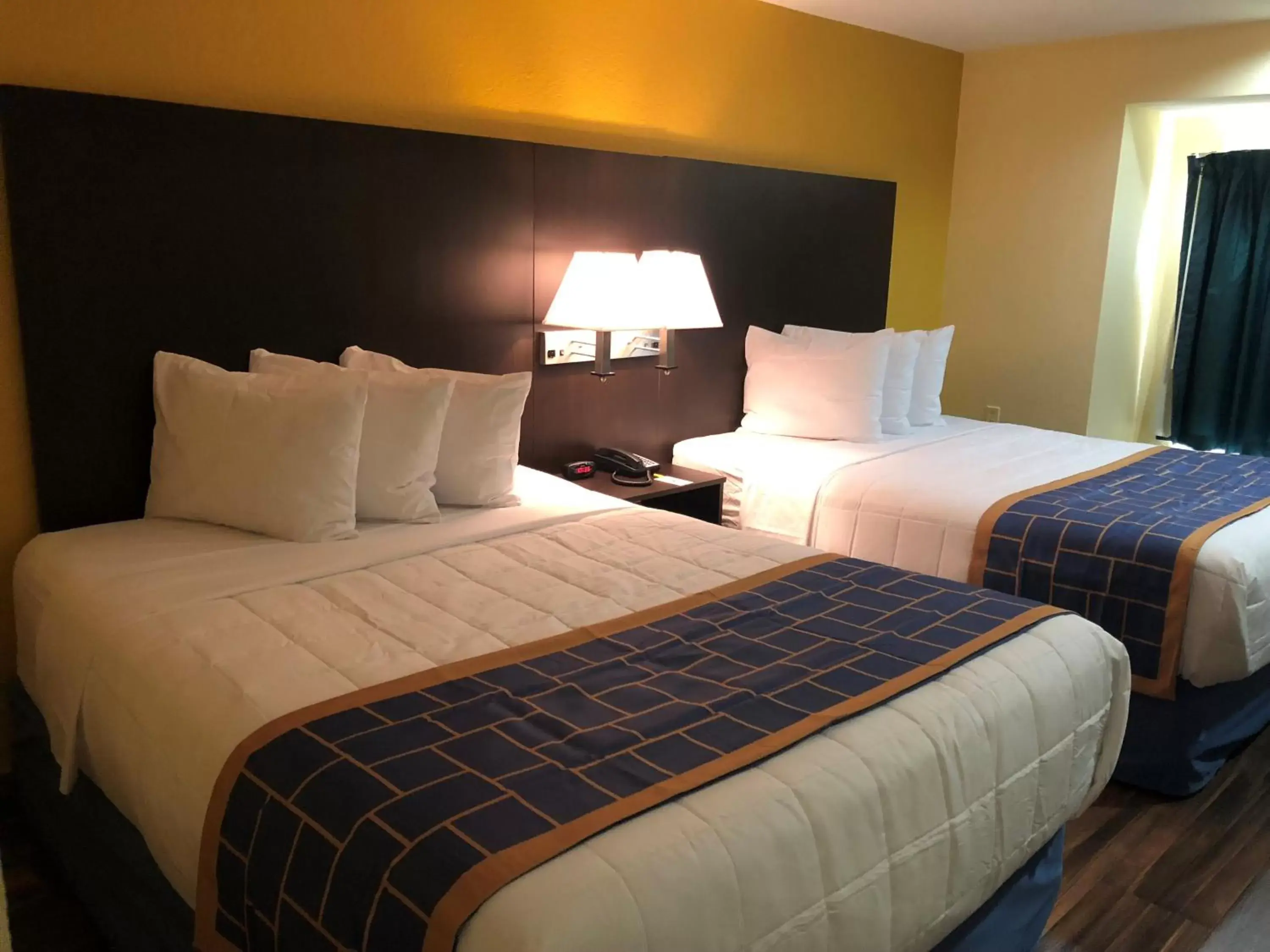 Decorative detail, Bed in Days Inn & Suites by Wyndham Tampa/Raymond James Stadium