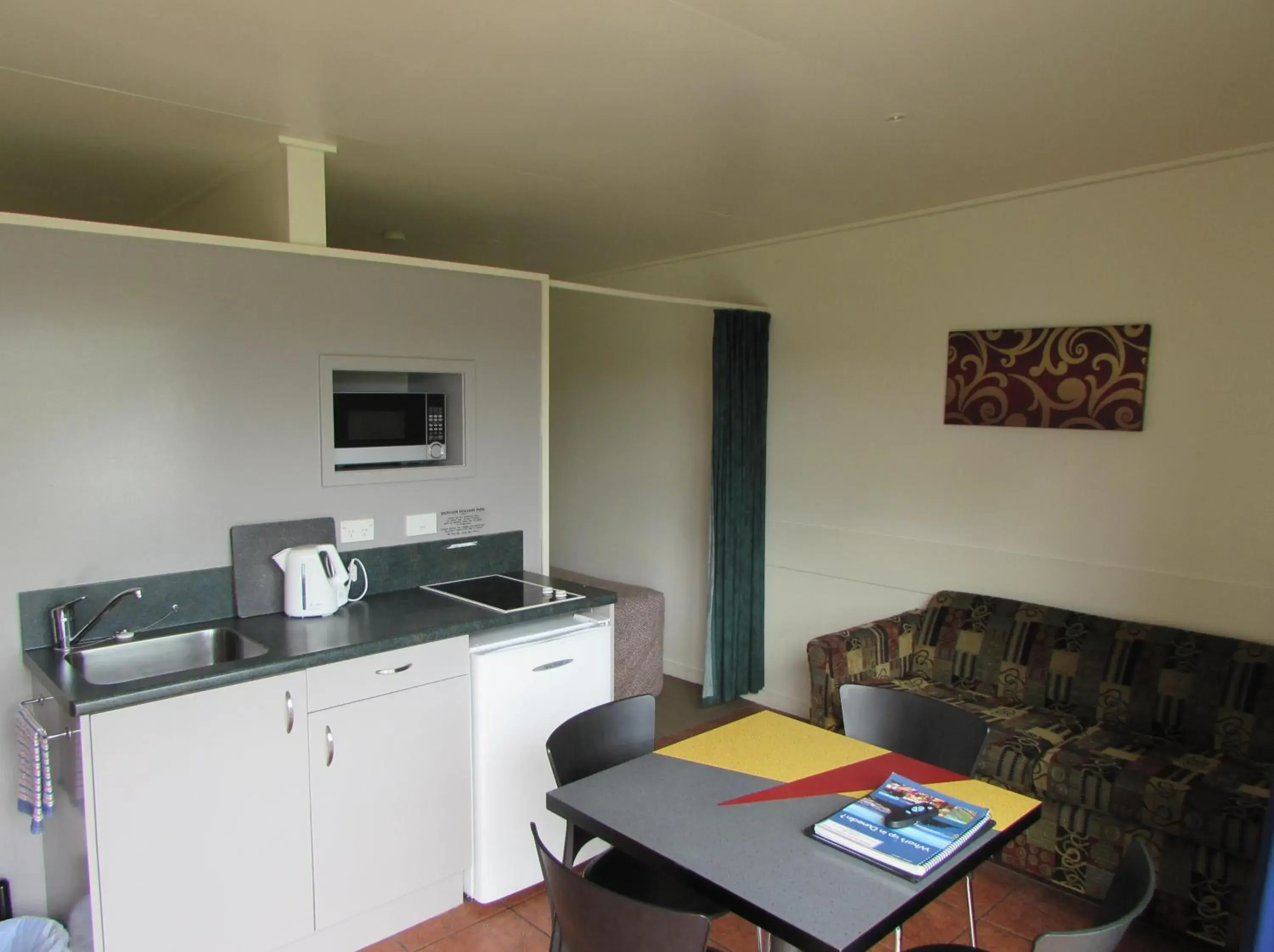 Kitchen or kitchenette, Dining Area in Dunedin Holiday Park