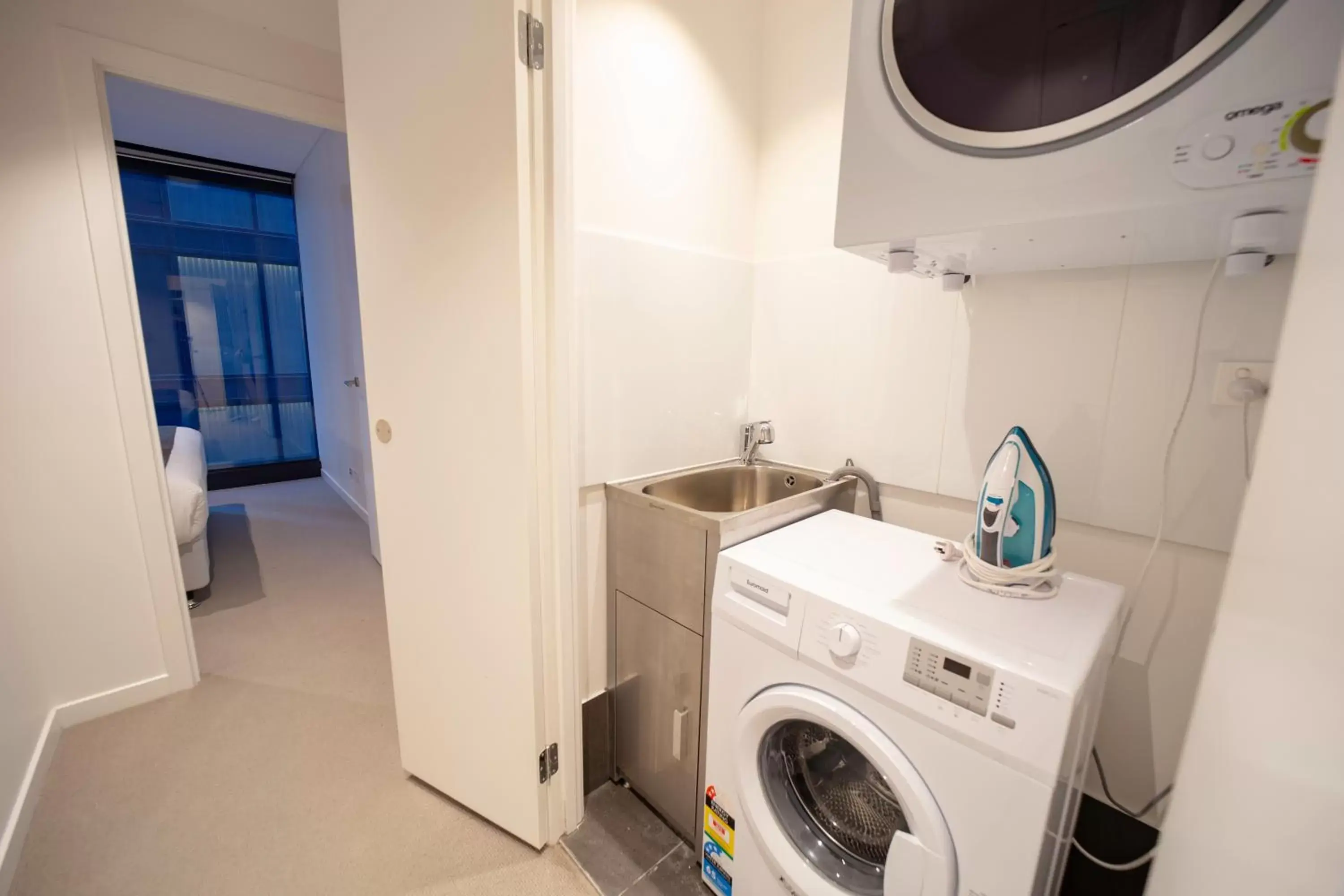 washing machine, Bathroom in Brisbane Skytower by CLLIX