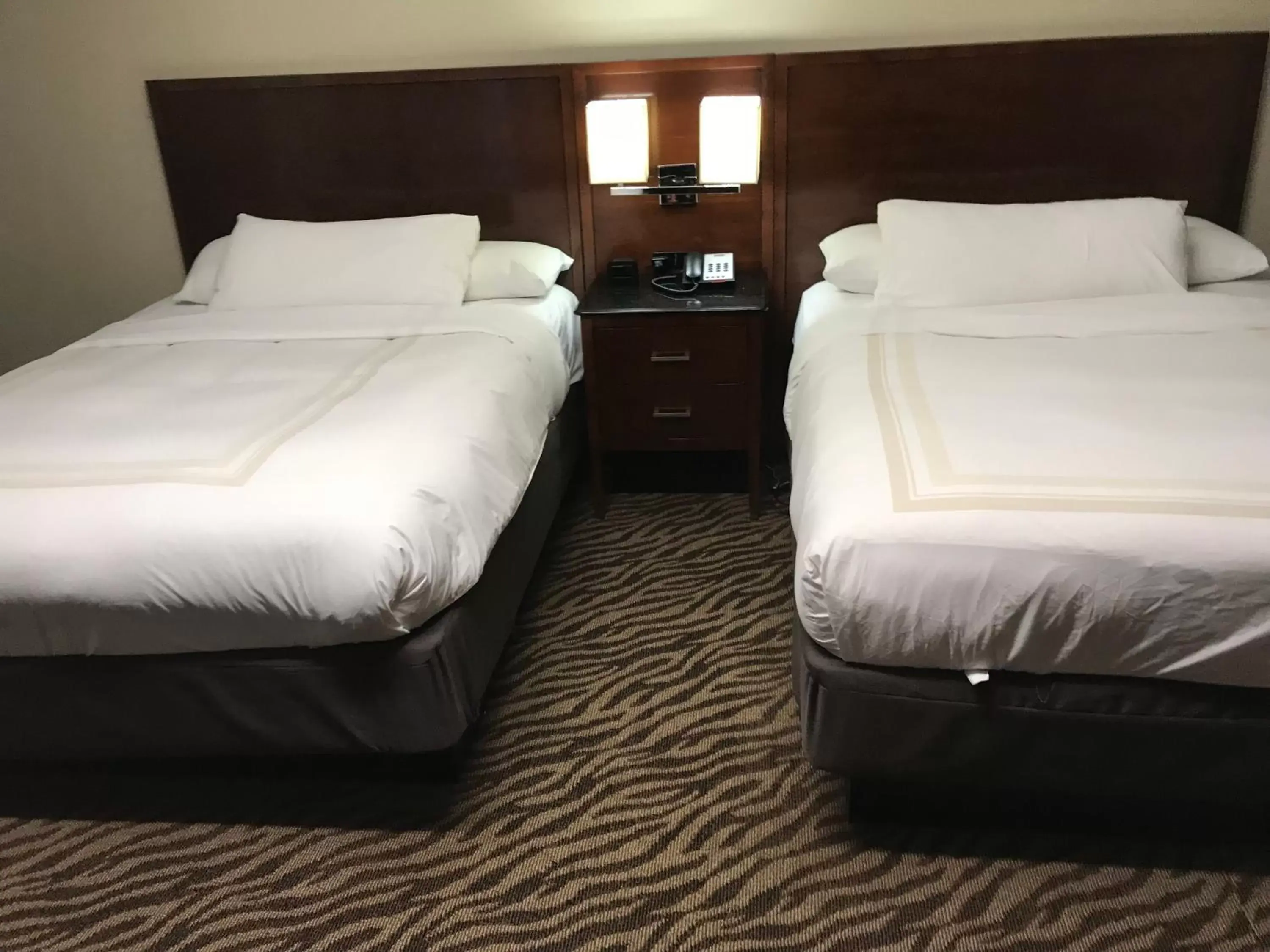 Bed in Hometown Inn & Suites