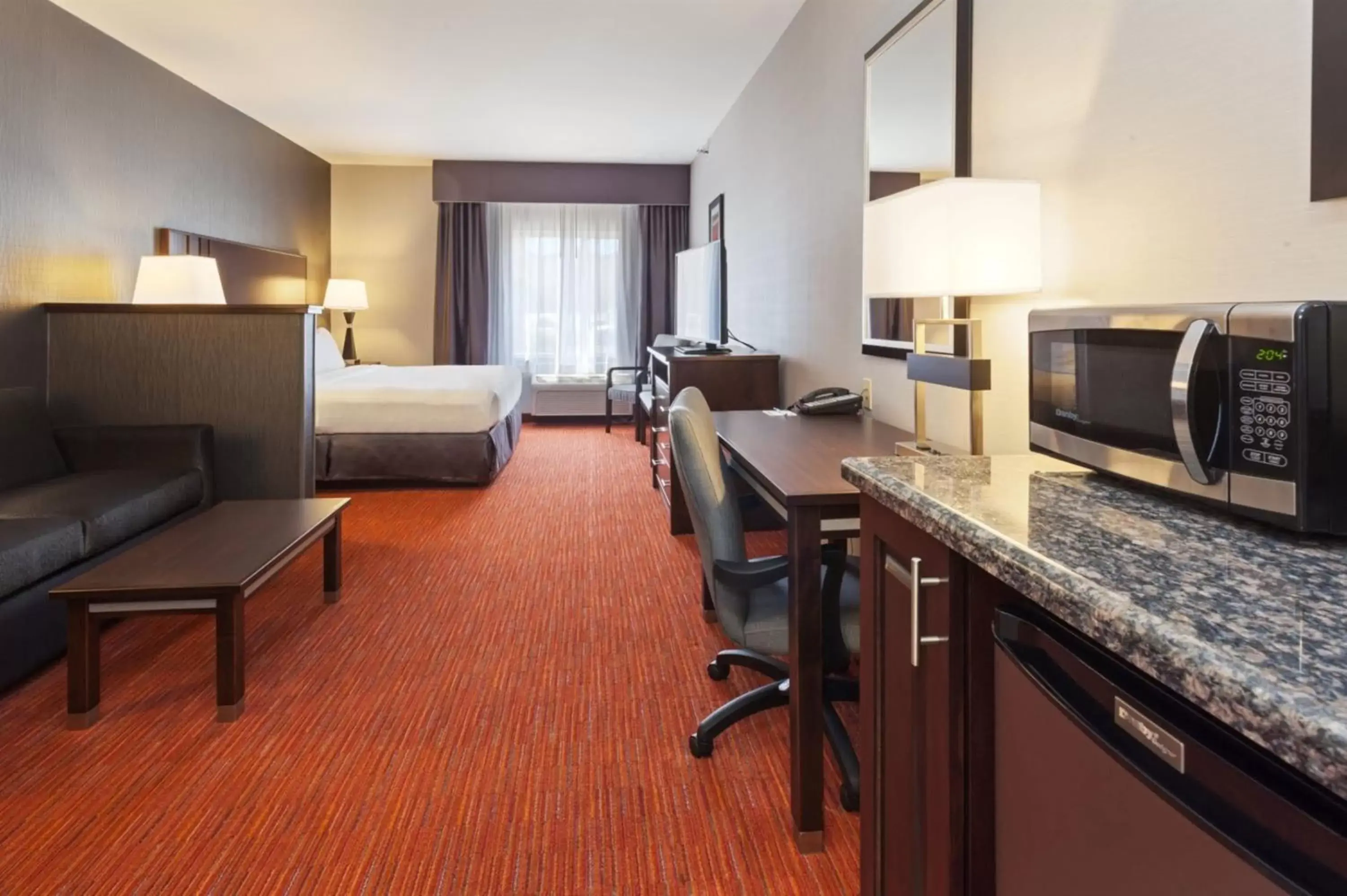 Bedroom, Kitchen/Kitchenette in Holiday Inn Express & Suites Rapid City, an IHG Hotel