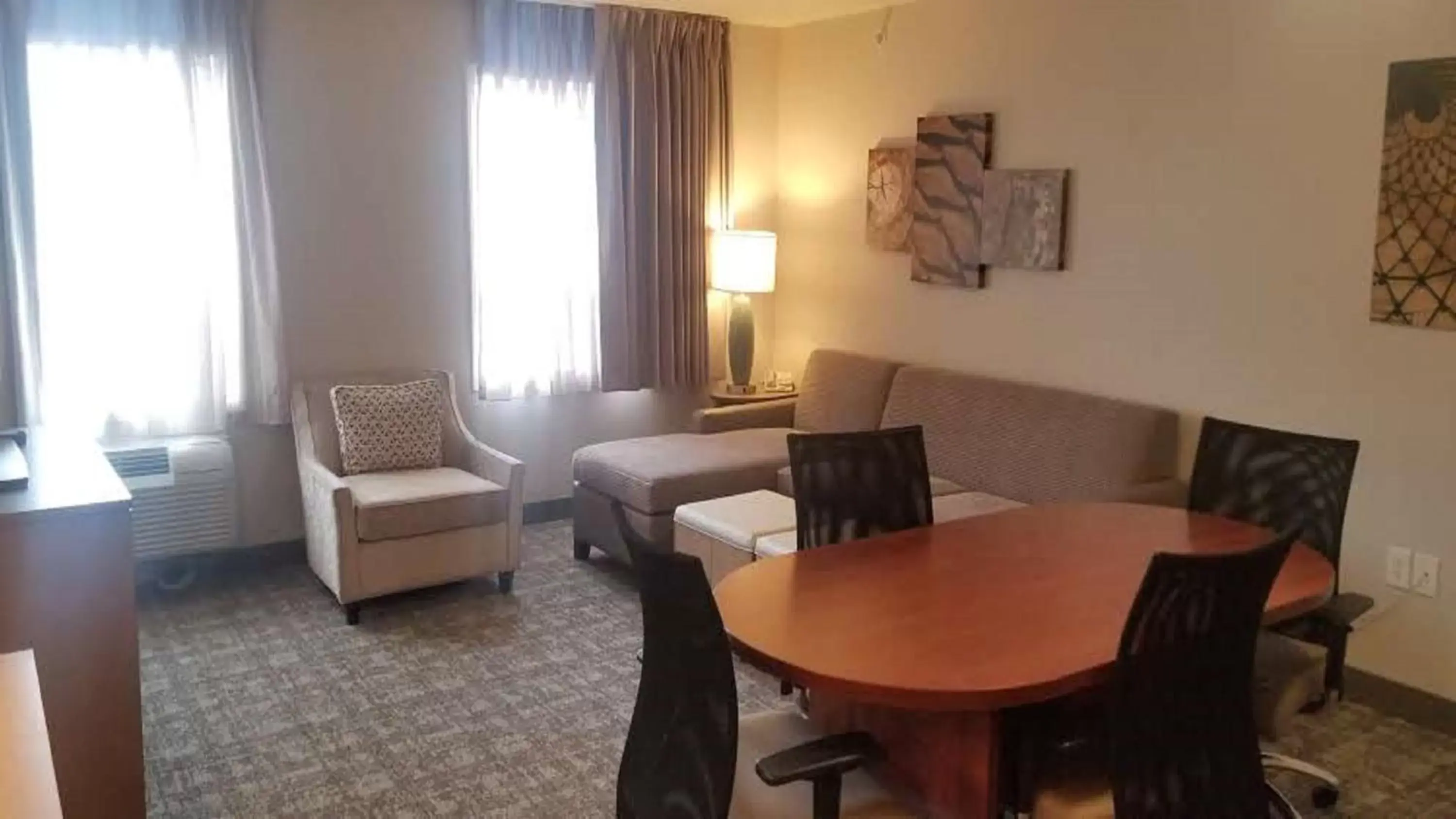 Bedroom, Dining Area in Staybridge Suites - Calgary Airport, an IHG Hotel