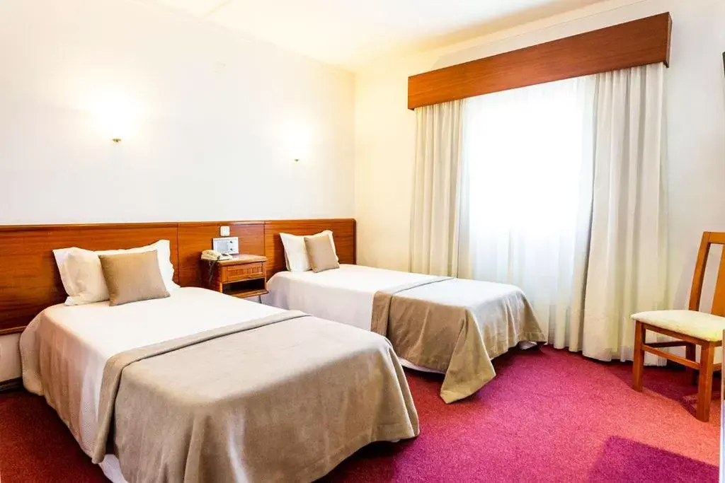 Bed in Dona Amélia Hotel by RIDAN Hotels