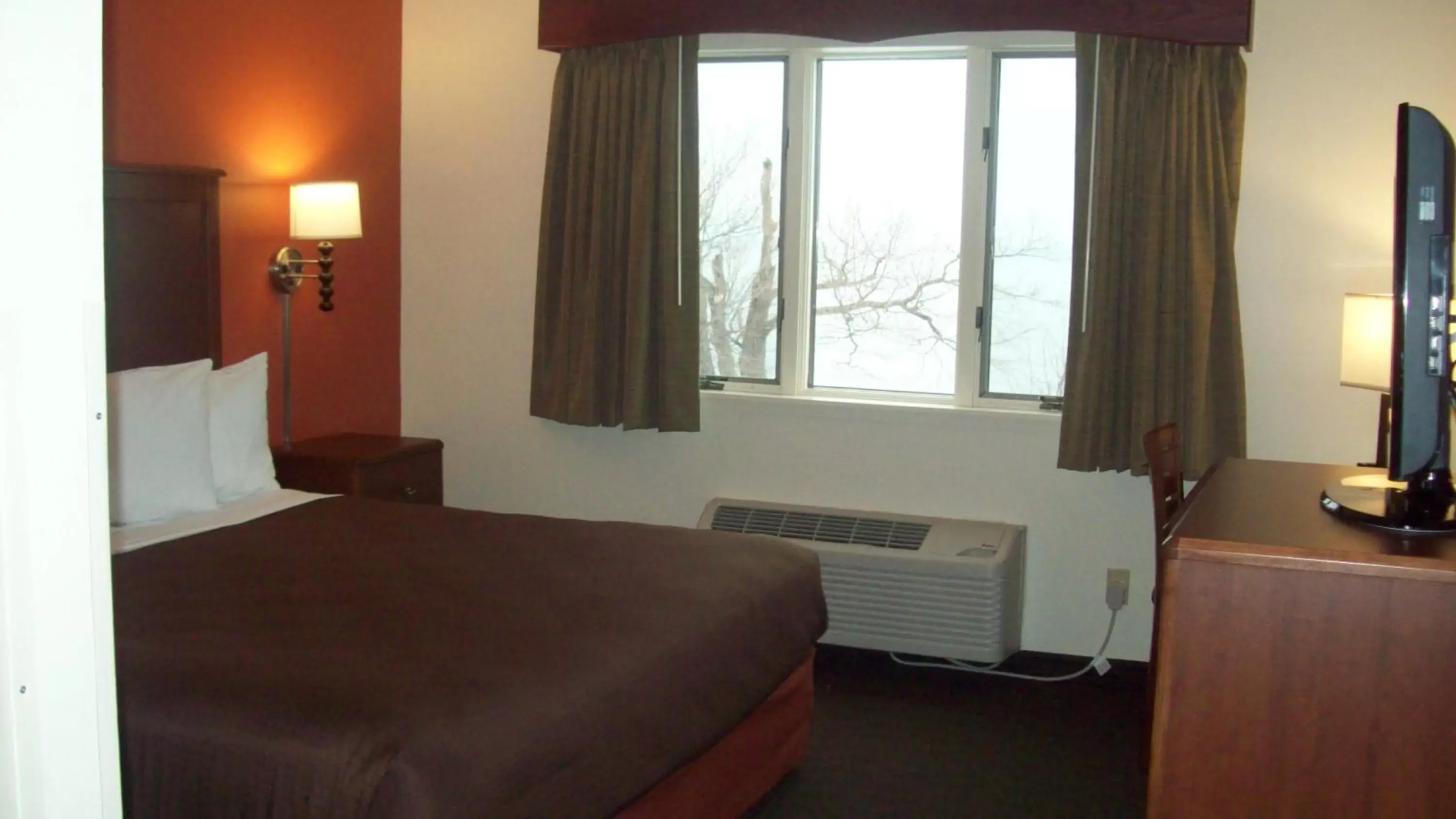 Bed in AmericInn by Wyndham Silver City