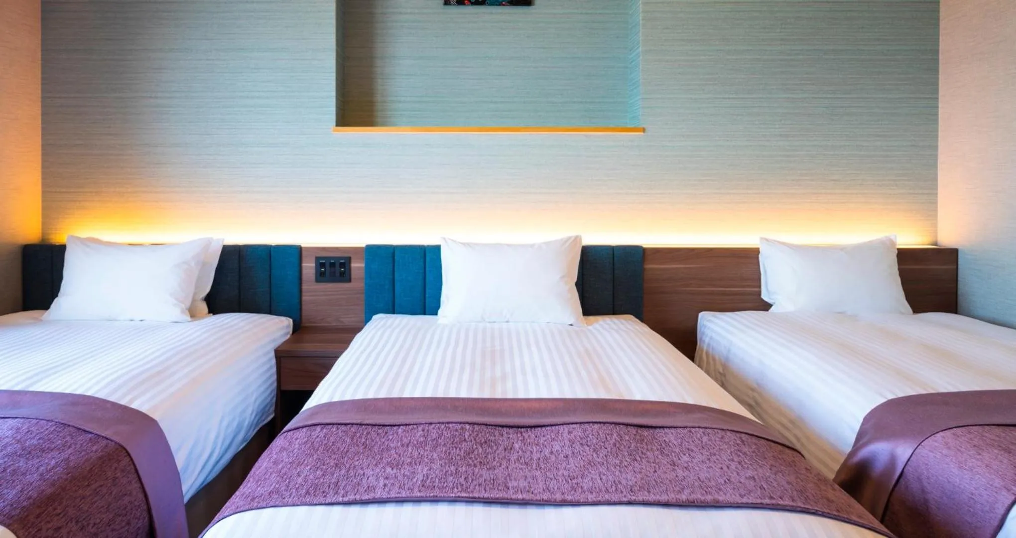 Bed in HOTEL SANSUI NAHA Ryukyu Onsen Naminoue-No-Yu