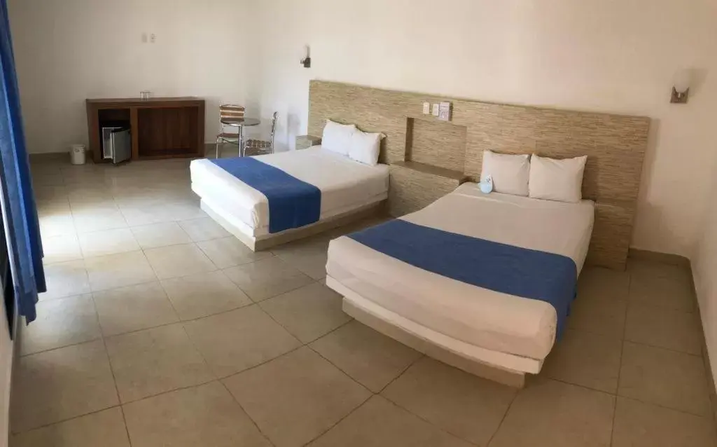 Photo of the whole room, Bed in Pelicano Inn Playa del Carmen - Beachfront Hotel