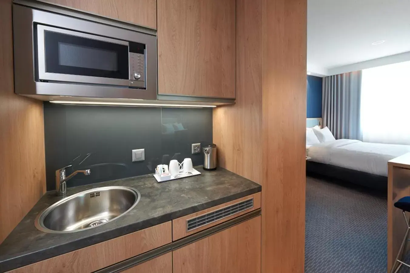 Photo of the whole room, Kitchen/Kitchenette in Holiday Inn Express & Suites - Basel - Allschwil, an IHG Hotel
