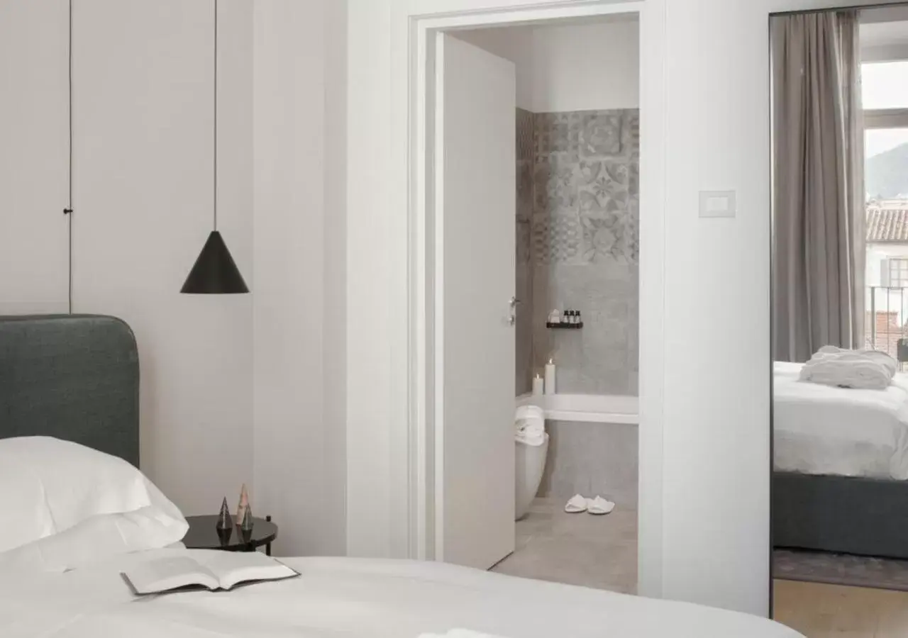 Bed, Bathroom in BB Hotels Aparthotel Collection Il Michelangelo