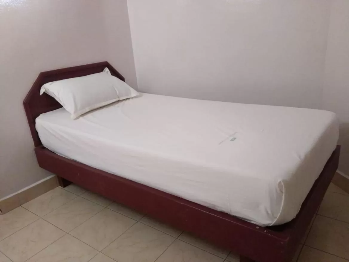 Bed in Anandan Tourist Home