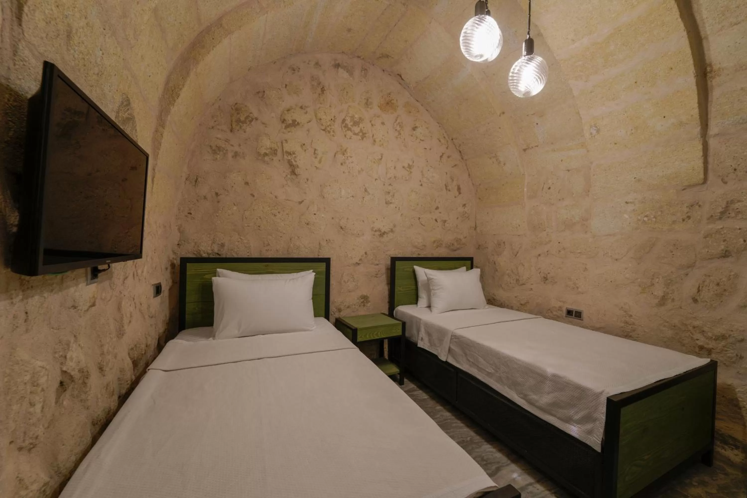 Bed in The Niche Cave Hotel