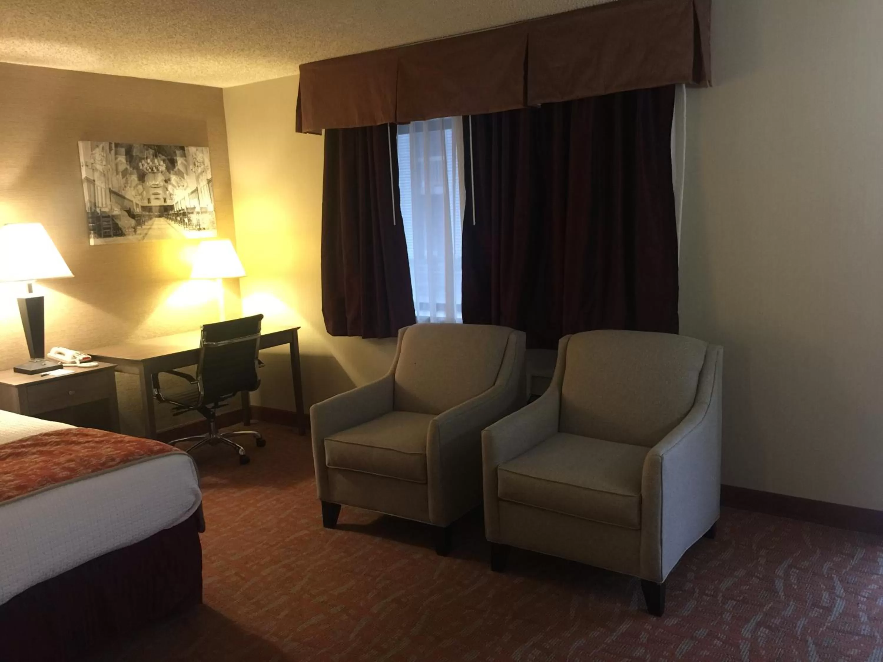 Seating area, Bed in MHO INN and SUITES