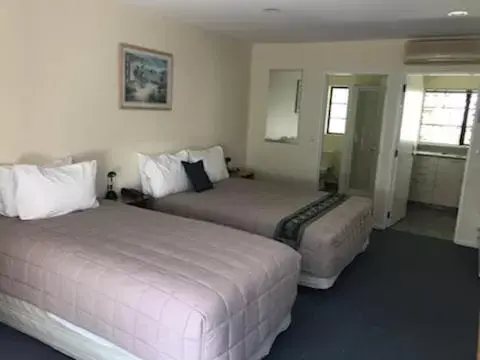 Bed in Tudor Lodge Motel