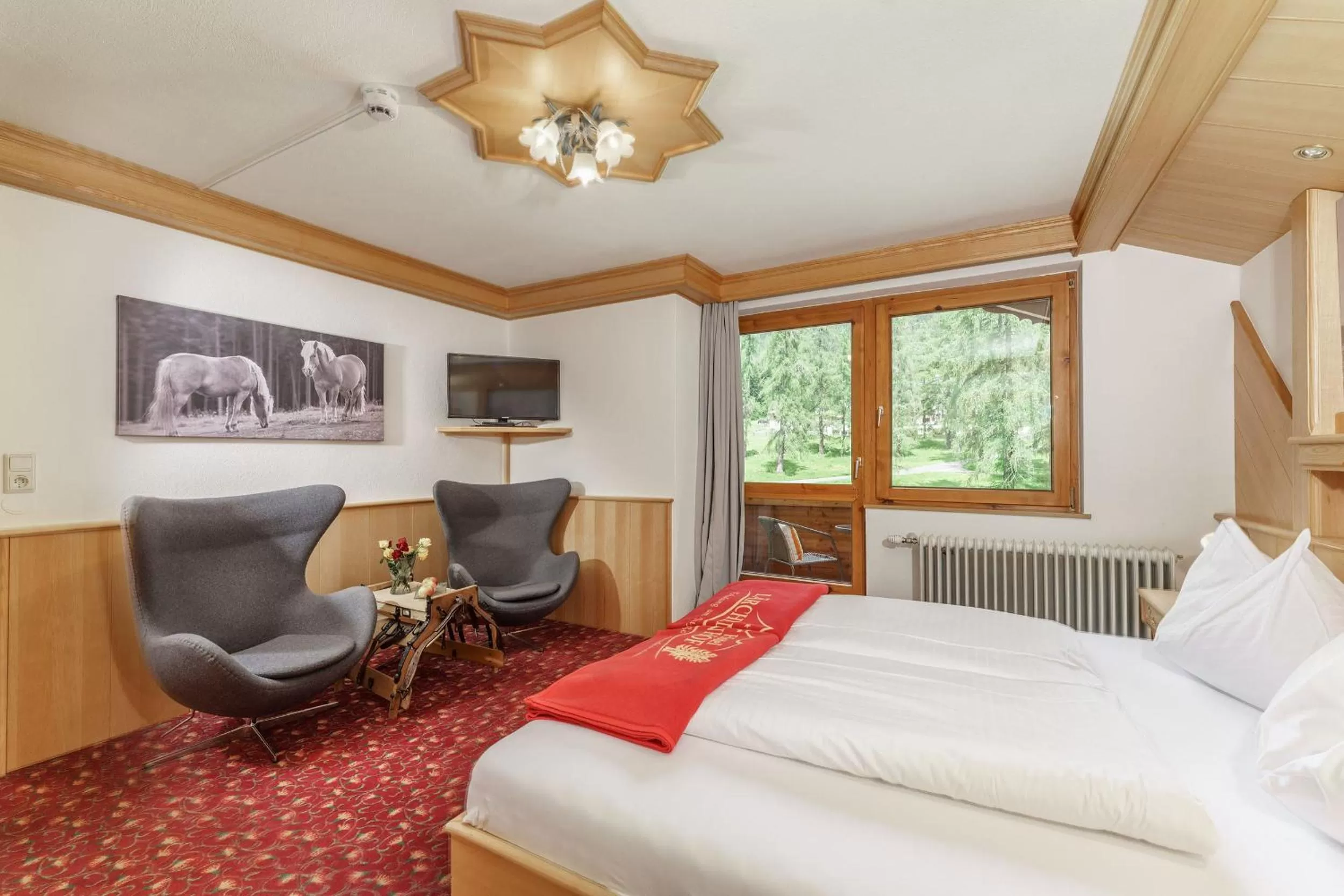 Seating area, Bed in Naturhotel Lärchenhof