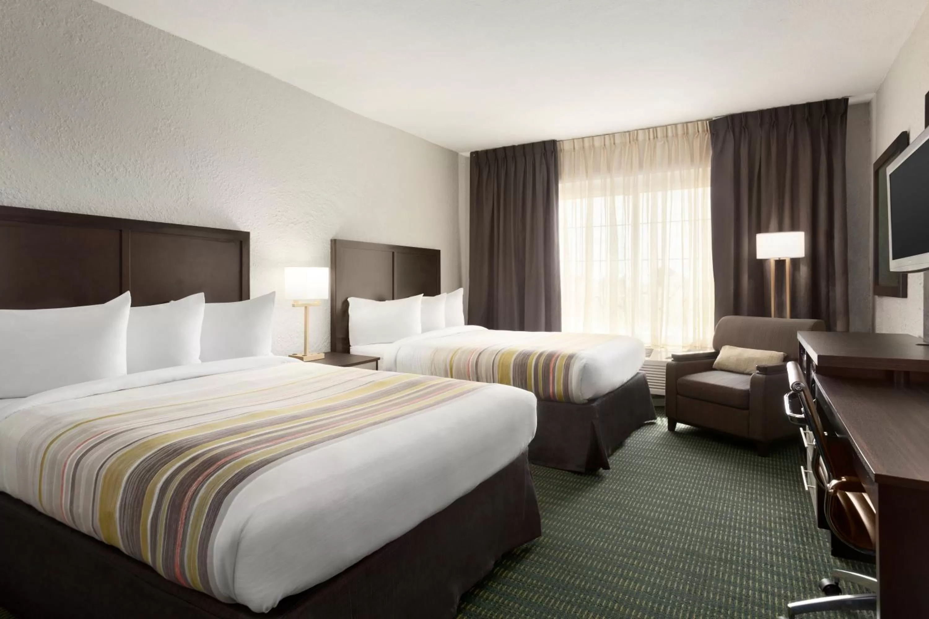 Seating area, Bed in SureStay Plus Hotel by Best Western Vero Beach