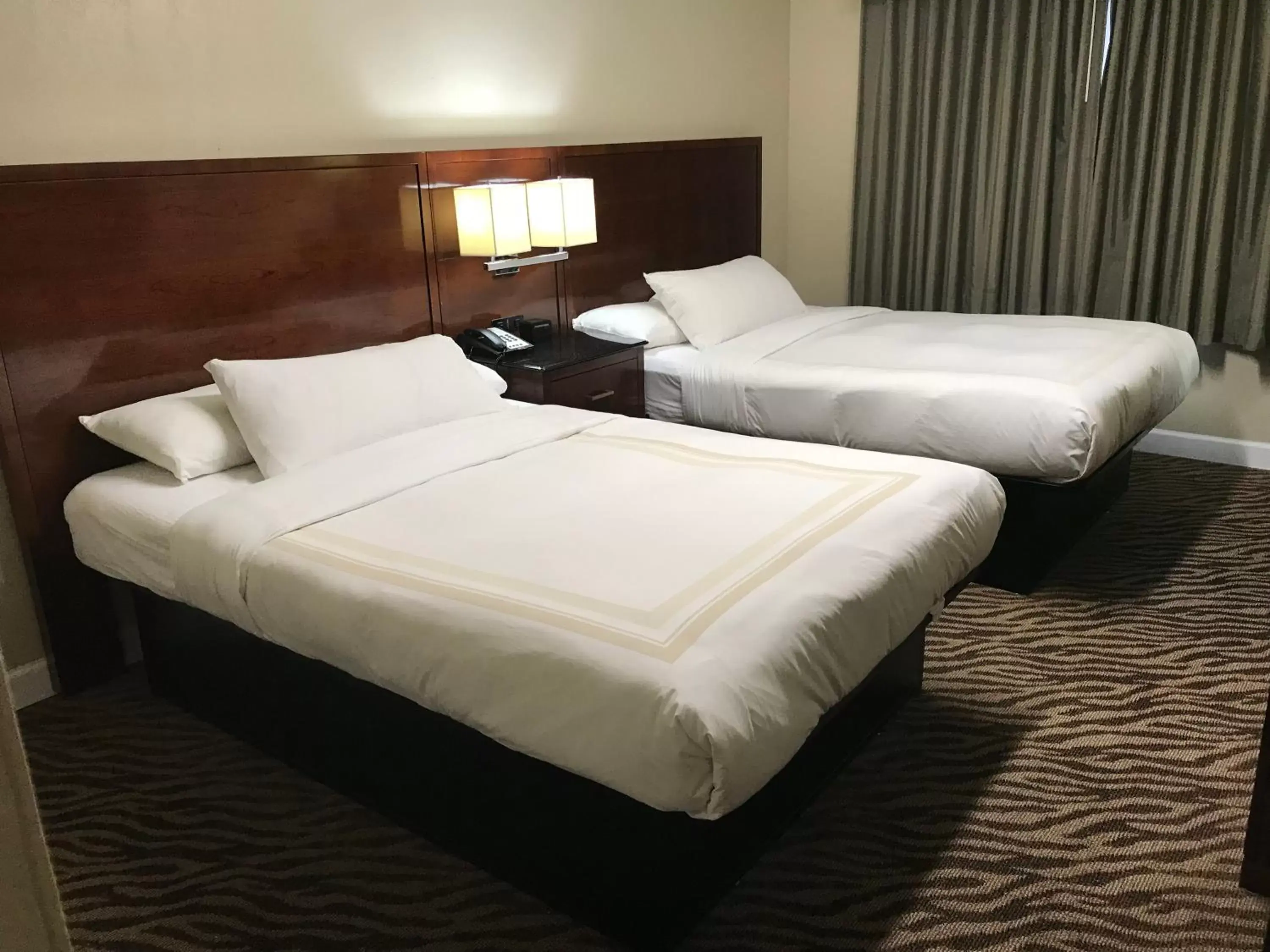 Bed in Hometown Inn & Suites