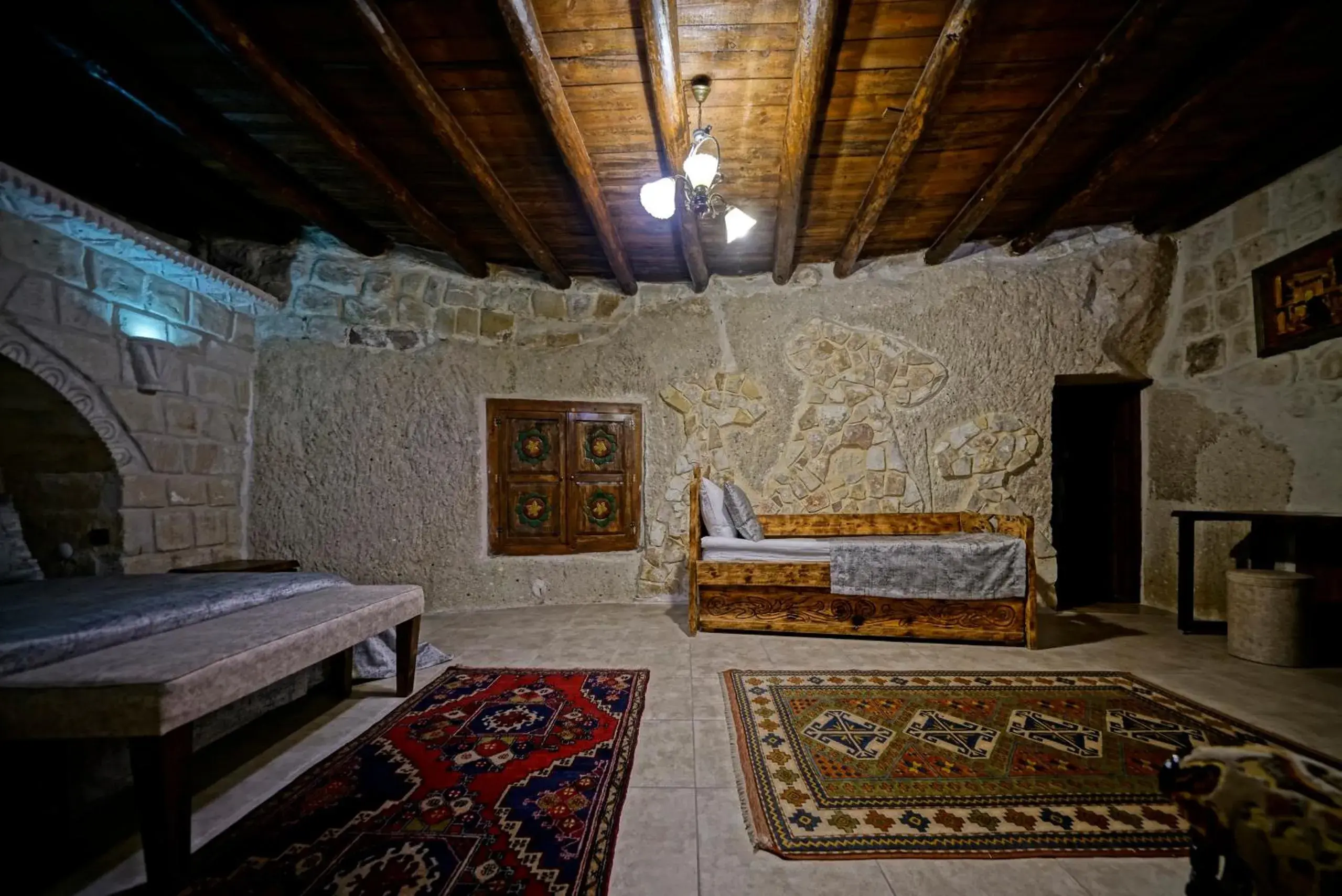 Bed, Seating Area in Holiday Cave Hotel