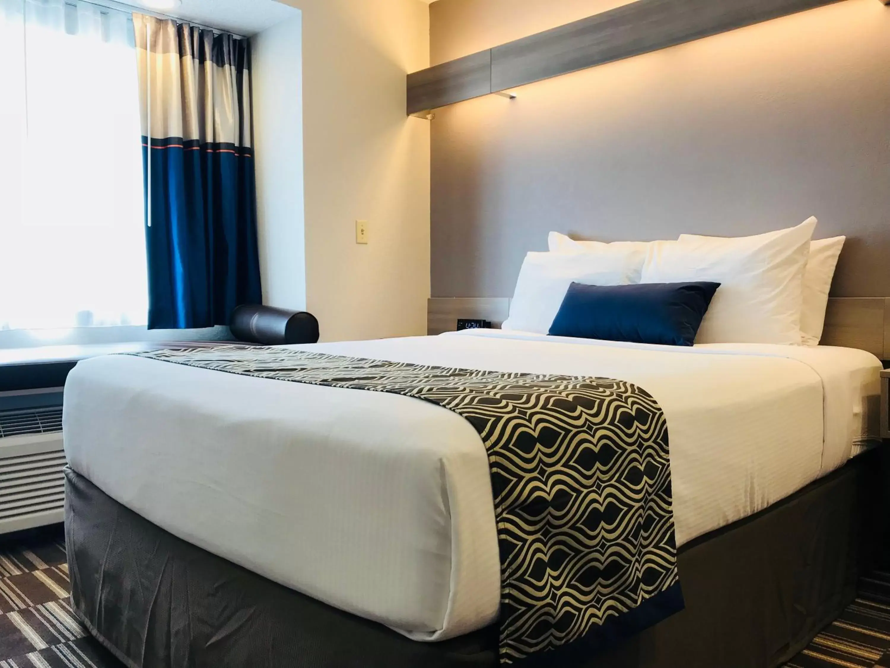 Bed in Microtel Inn & Suites by Wyndham Atlanta Buckhead Area
