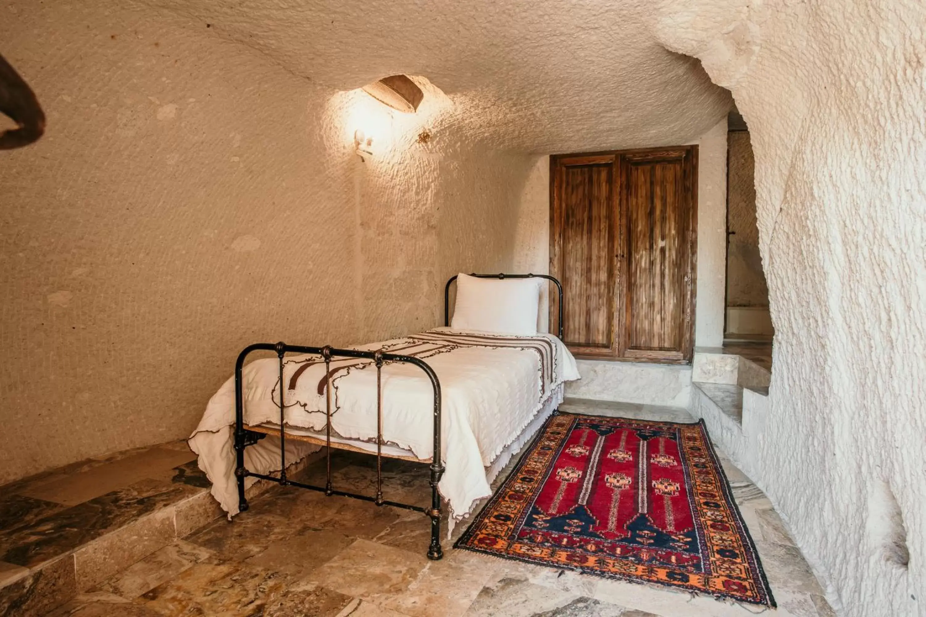 Bed in Village Cave House Hotel