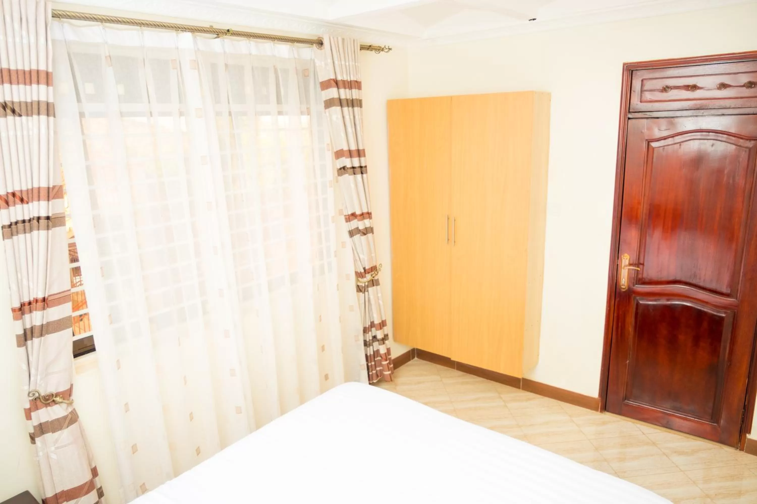 Photo of the whole room, Bed in Kampala Suburbs Apartment