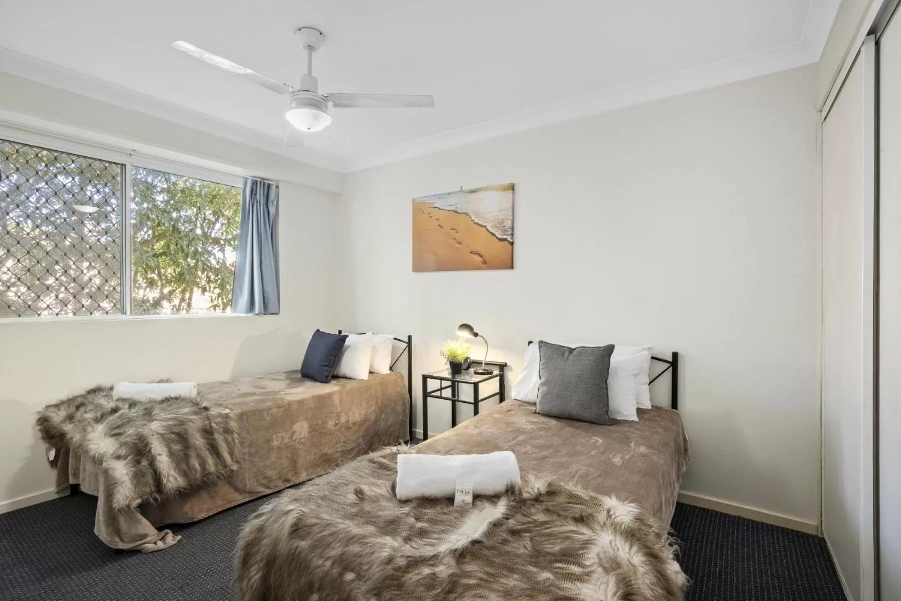 Bed in Kirra Palms Holiday Apartments