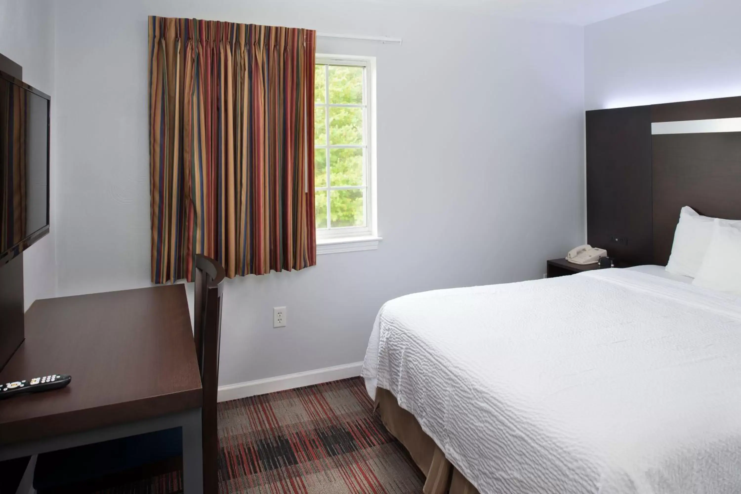 Bed in Luxbury Inn & Suites