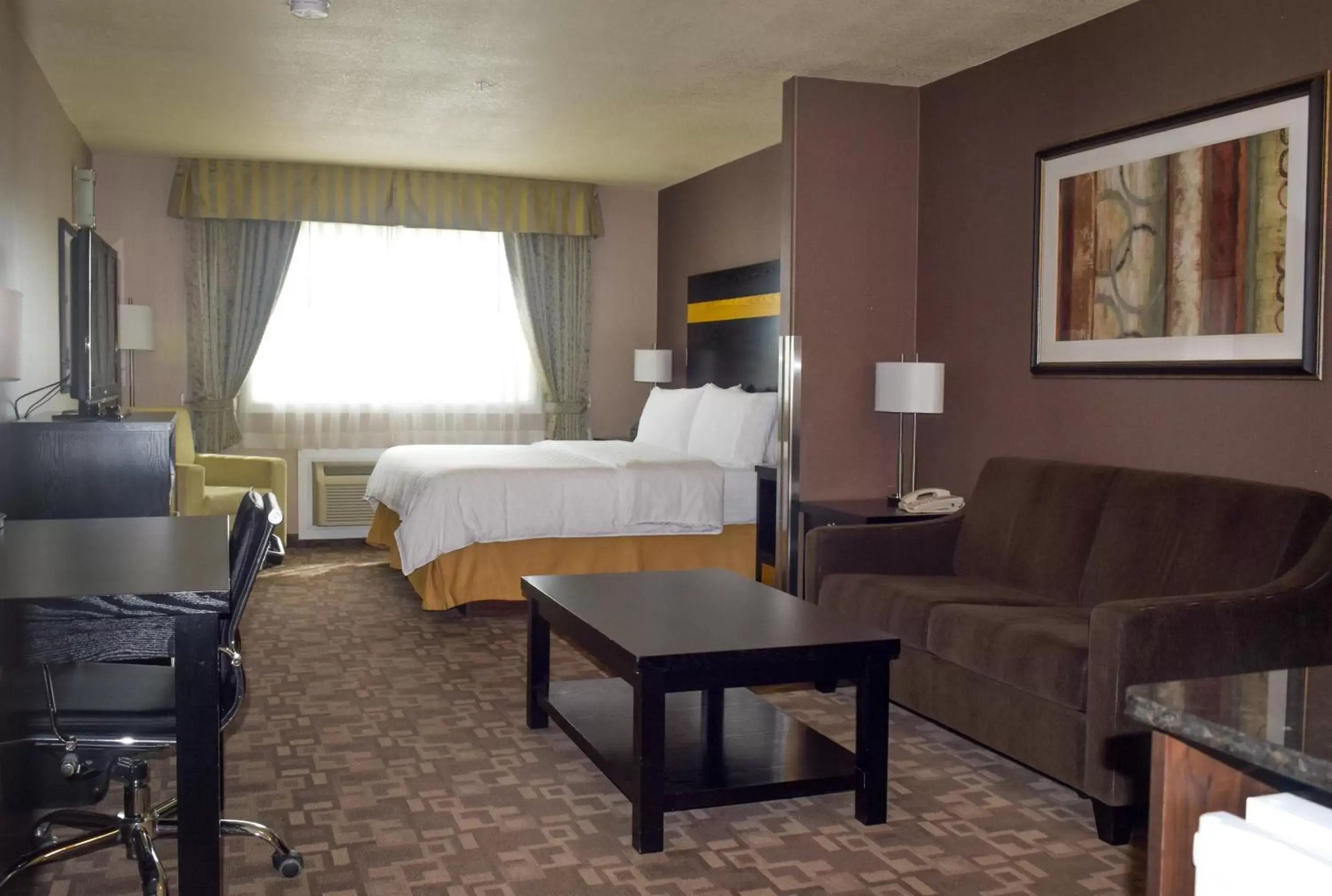 Bedroom, Seating Area in Holiday Inn Express and Suites Dawson Creek, an IHG Hotel