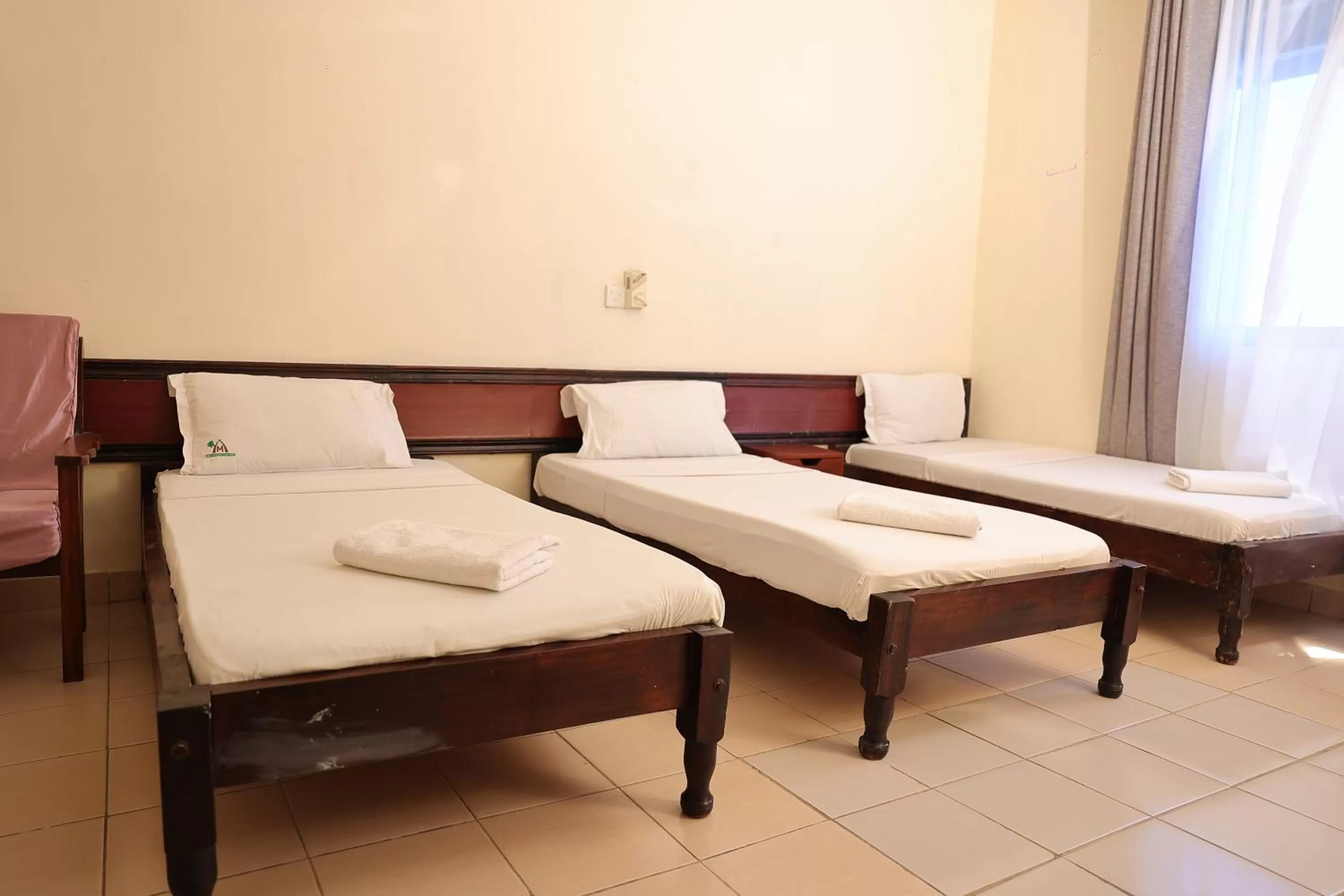 Bed in Merry Villa Hotel & Apartments