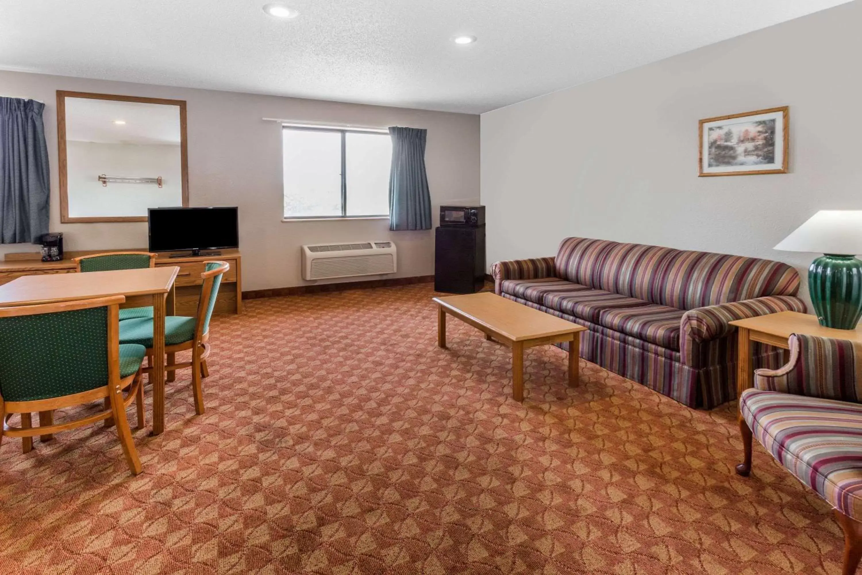 Photo of the whole room, Seating Area in Super 8 by Wyndham St. Charles