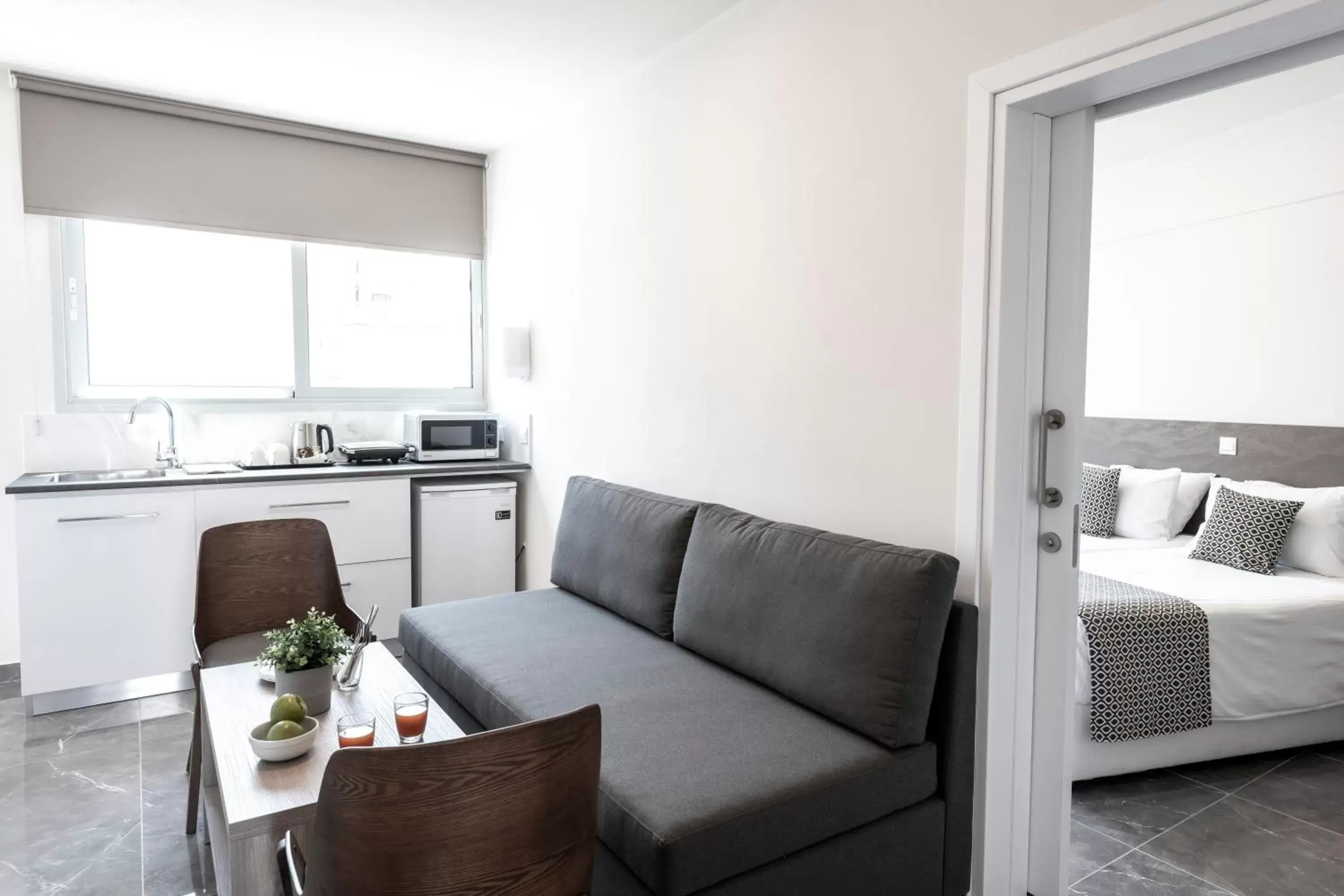 Bed, Seating Area in Blazer Residence