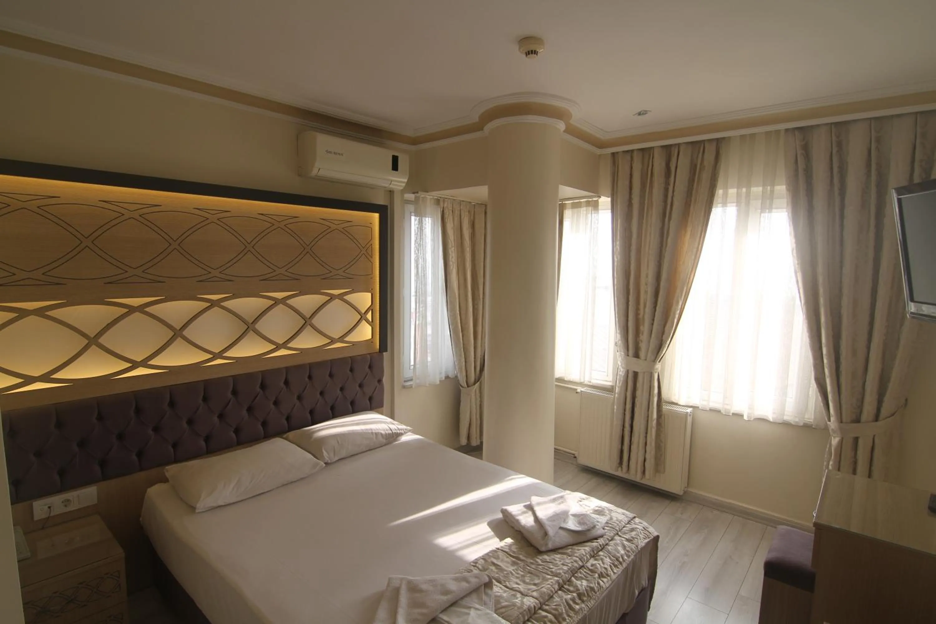 Bed in Grand Liza Hotel