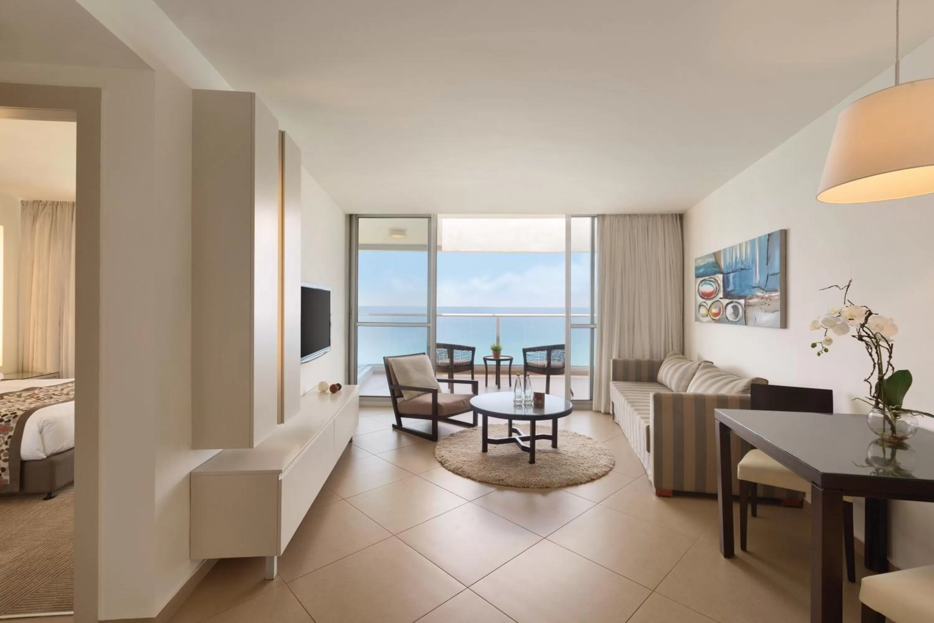 Living room, Bed in Ramada Hotel & Suites by Wyndham Netanya
