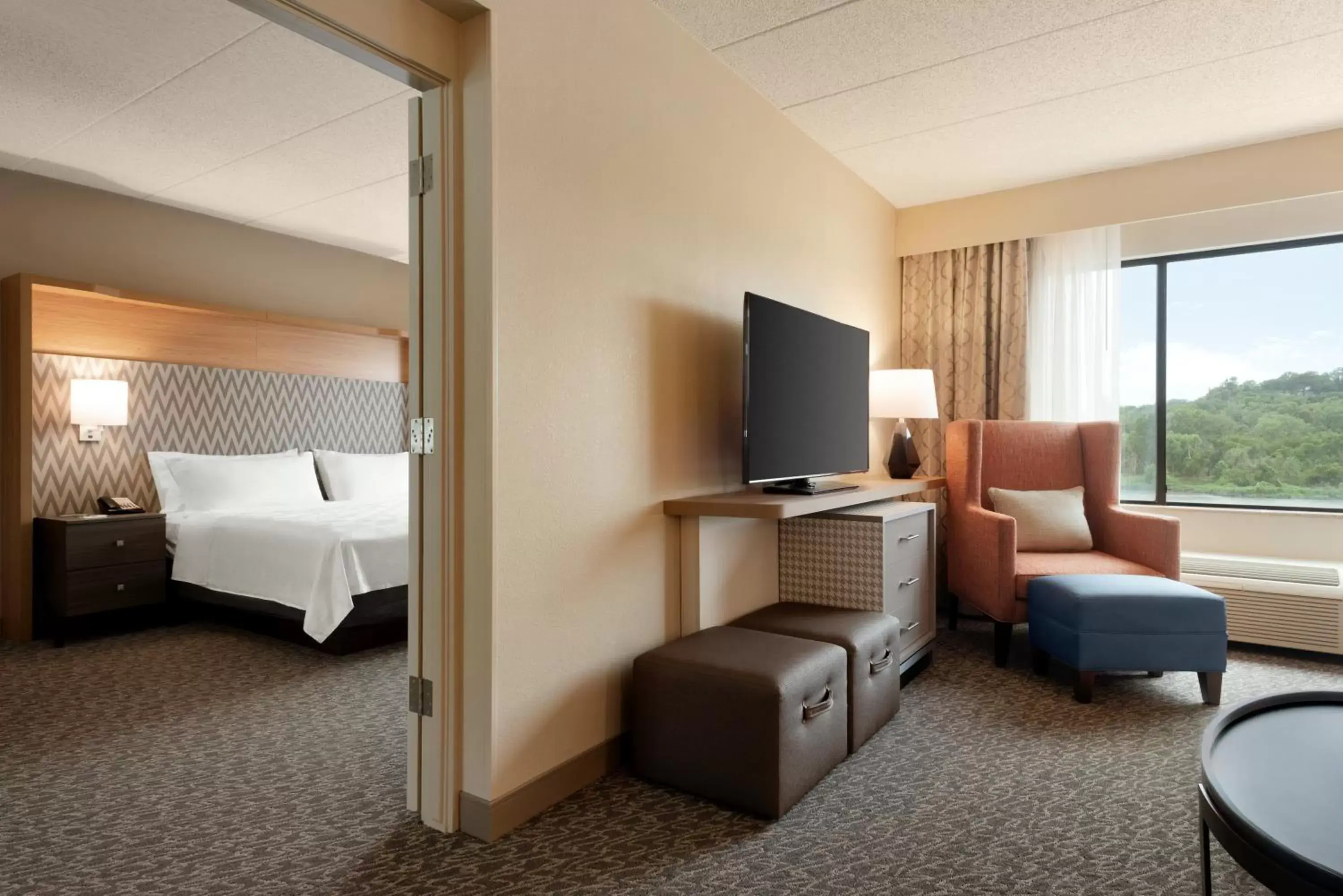 Bedroom, TV/Entertainment Center in Holiday Inn Hotel & Suites Council Bluffs, an IHG Hotel