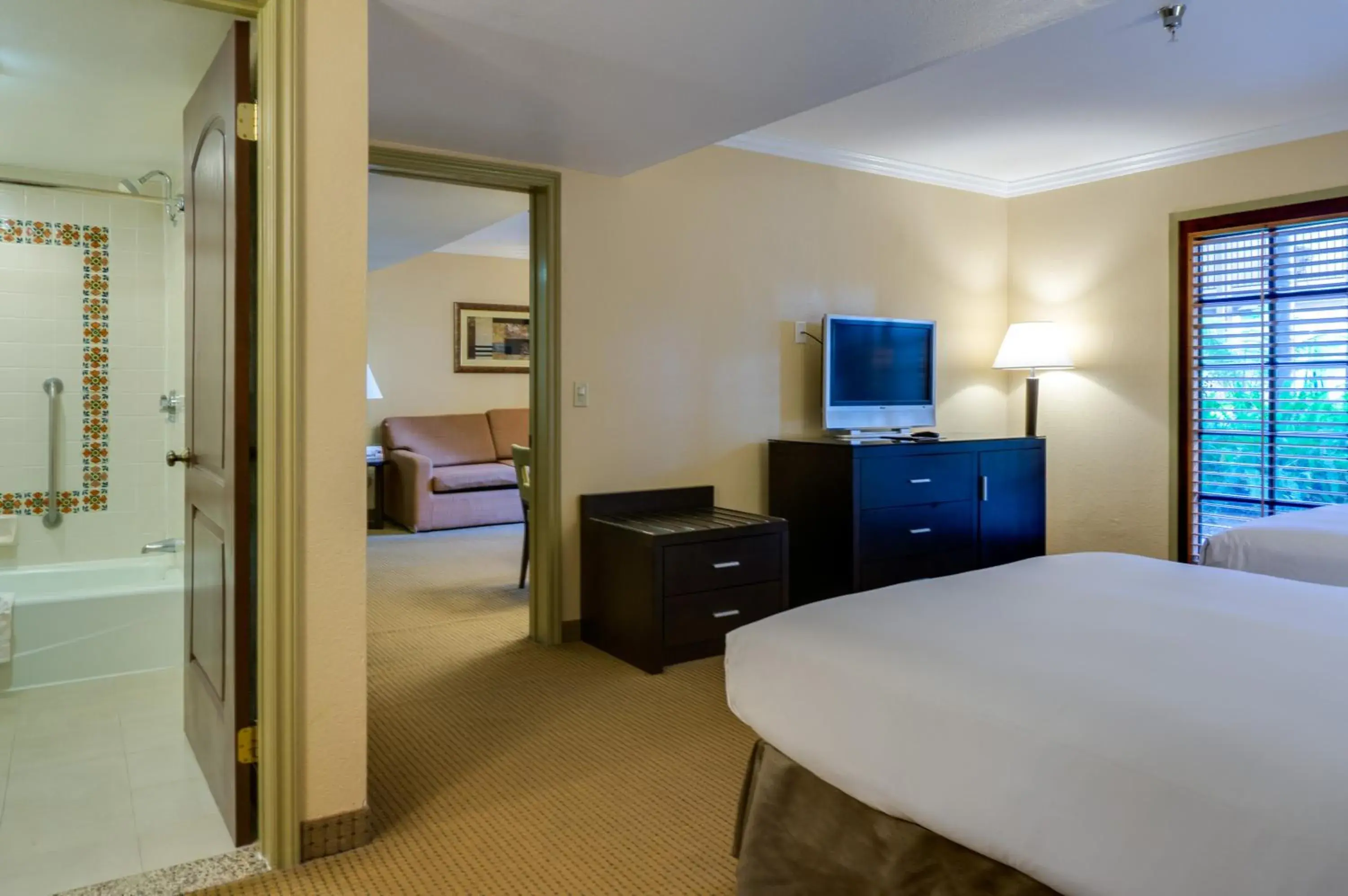 Bedroom, TV/Entertainment Center in Buena Park Grand Hotel & Suites