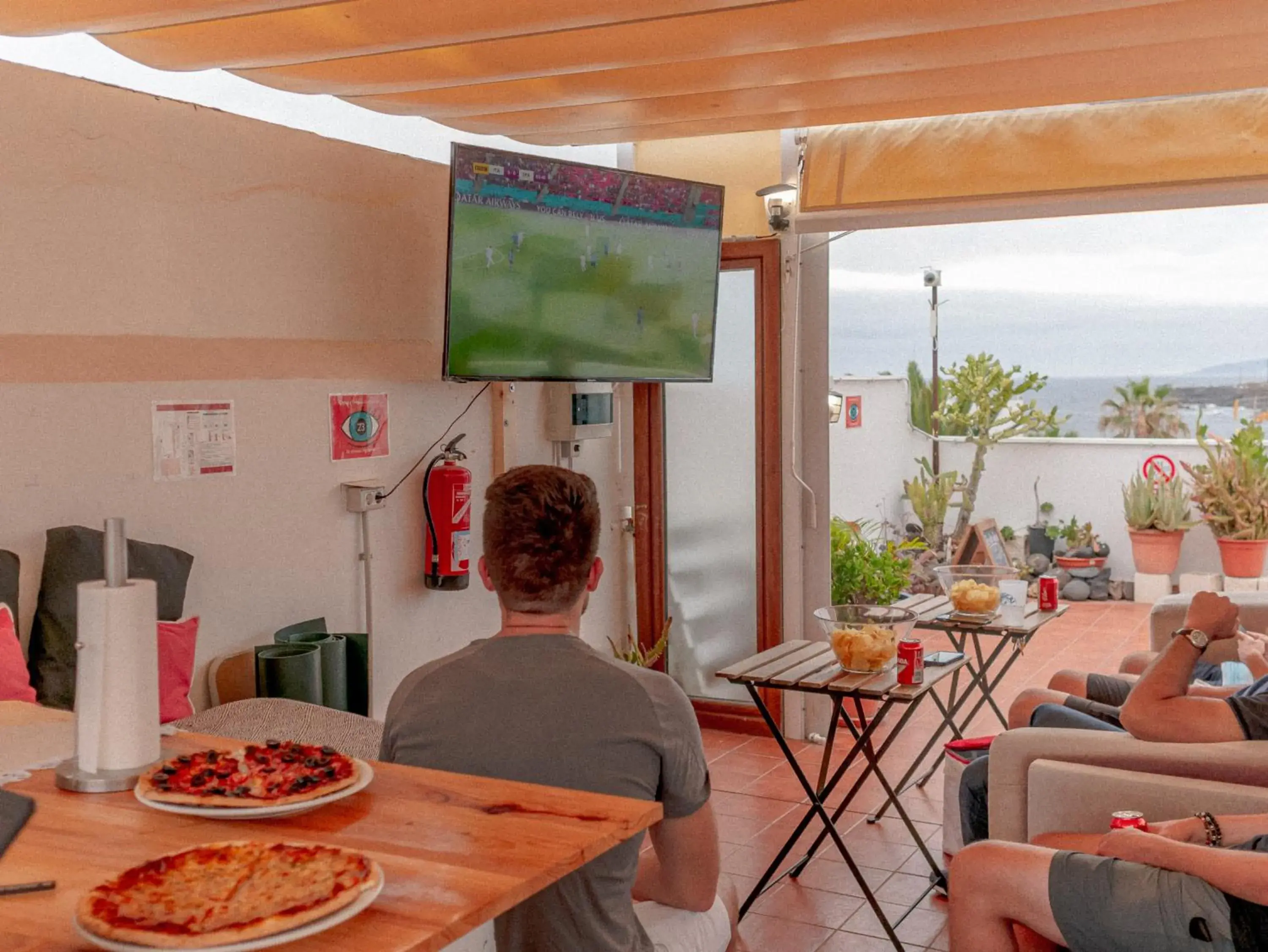 Communal lounge/ TV room in Puerto Nest Hostel