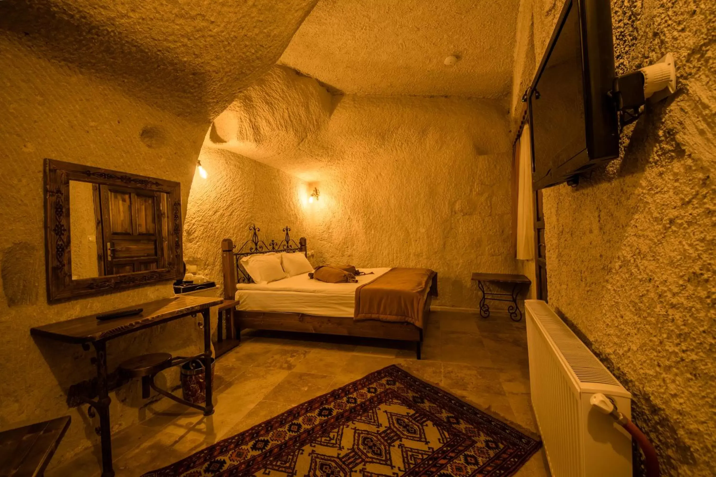 Bed in Elite Cave Suites