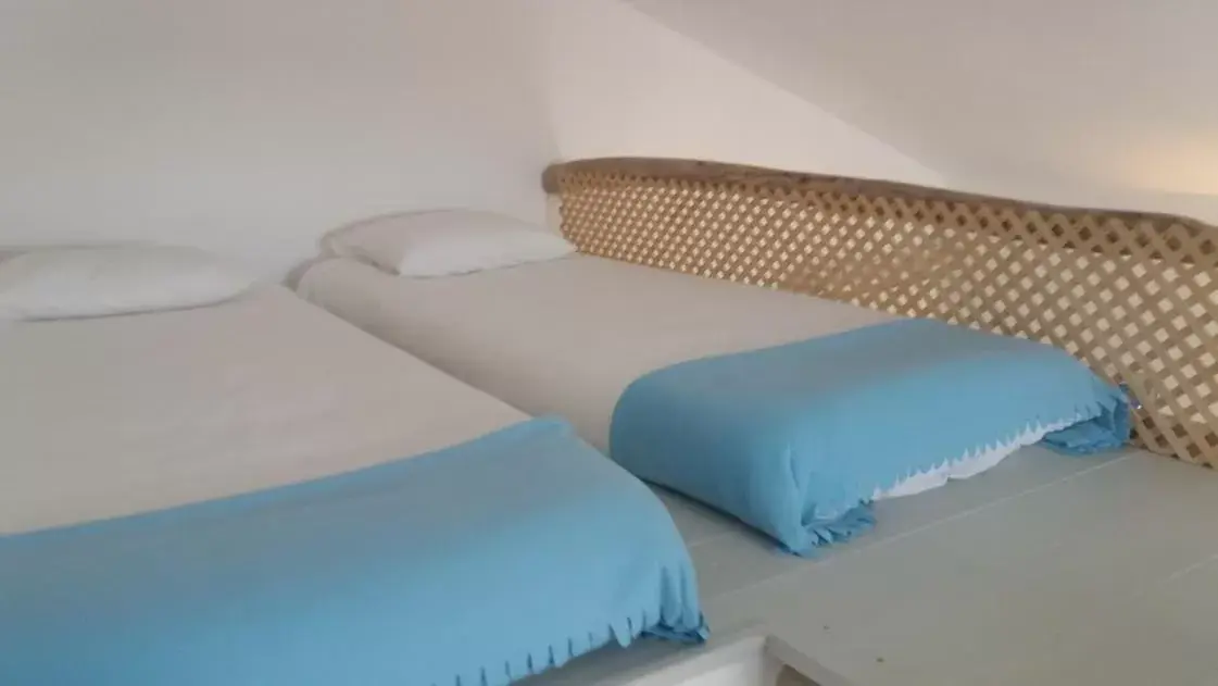 Bed in PuraVida Divehouse