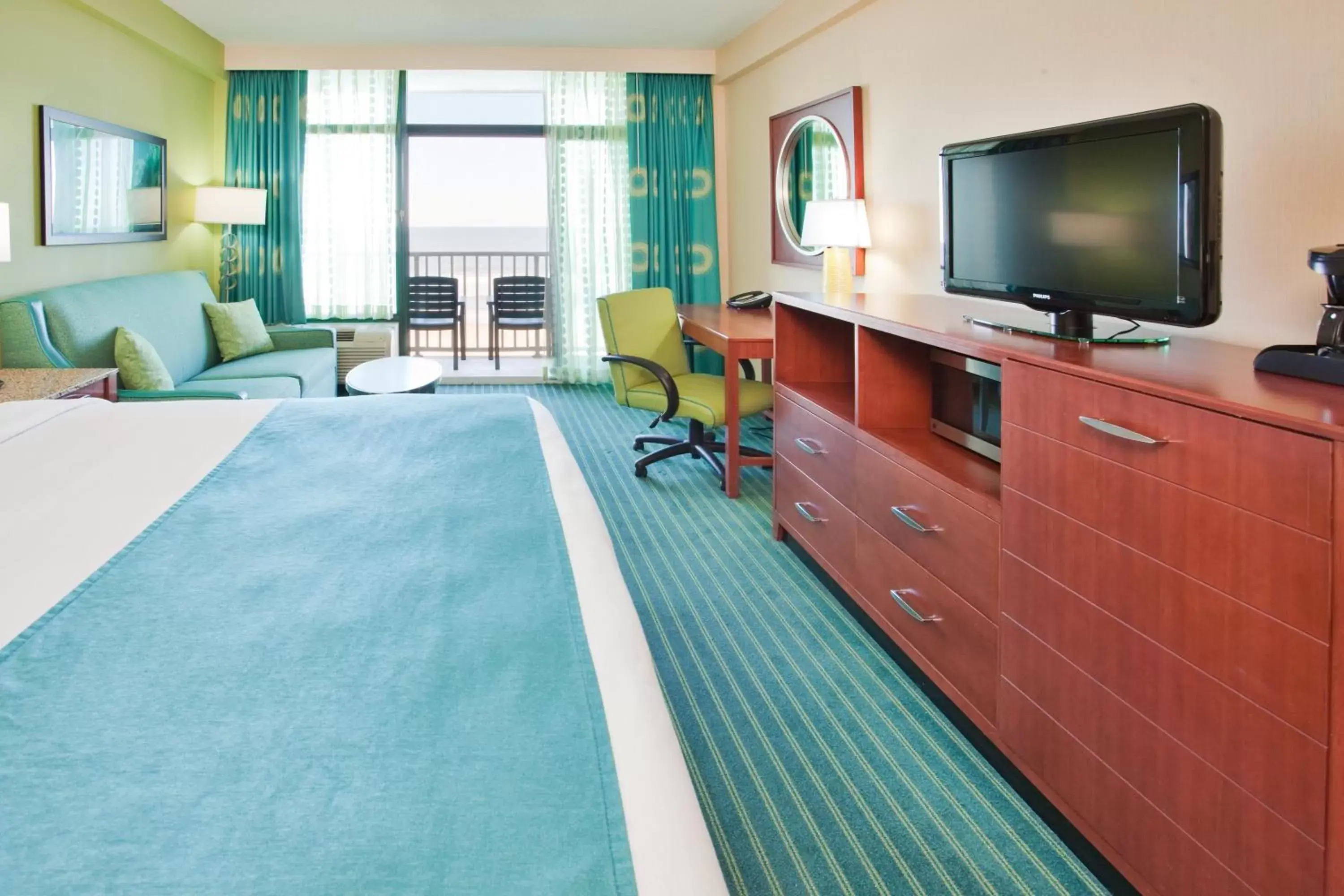 Photo of the whole room, TV/Entertainment Center in Holiday Inn & Suites Virginia Beach - North Beach, an IHG Hotel