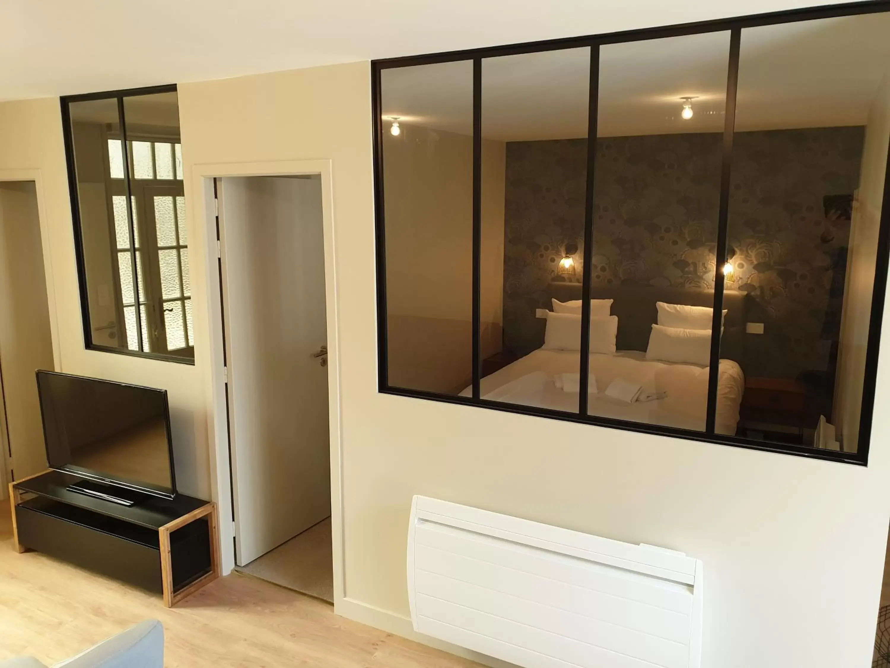 Bed, TV/Entertainment Center in Au Loup Historic Apartments