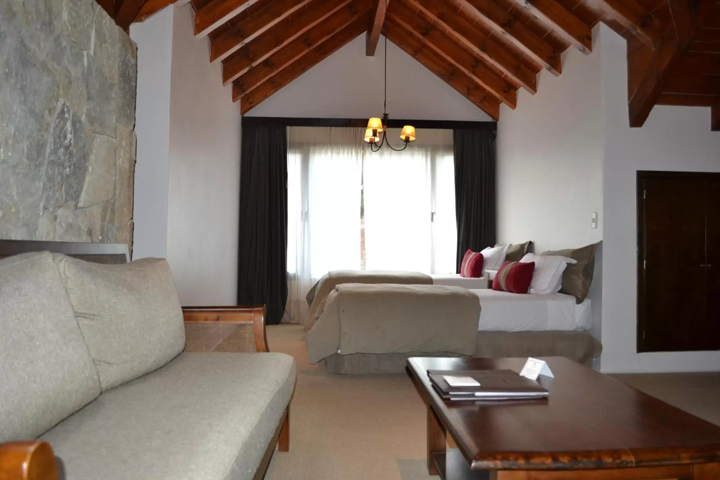 Bed, Seating Area in Loi Suites Chapelco Hotel