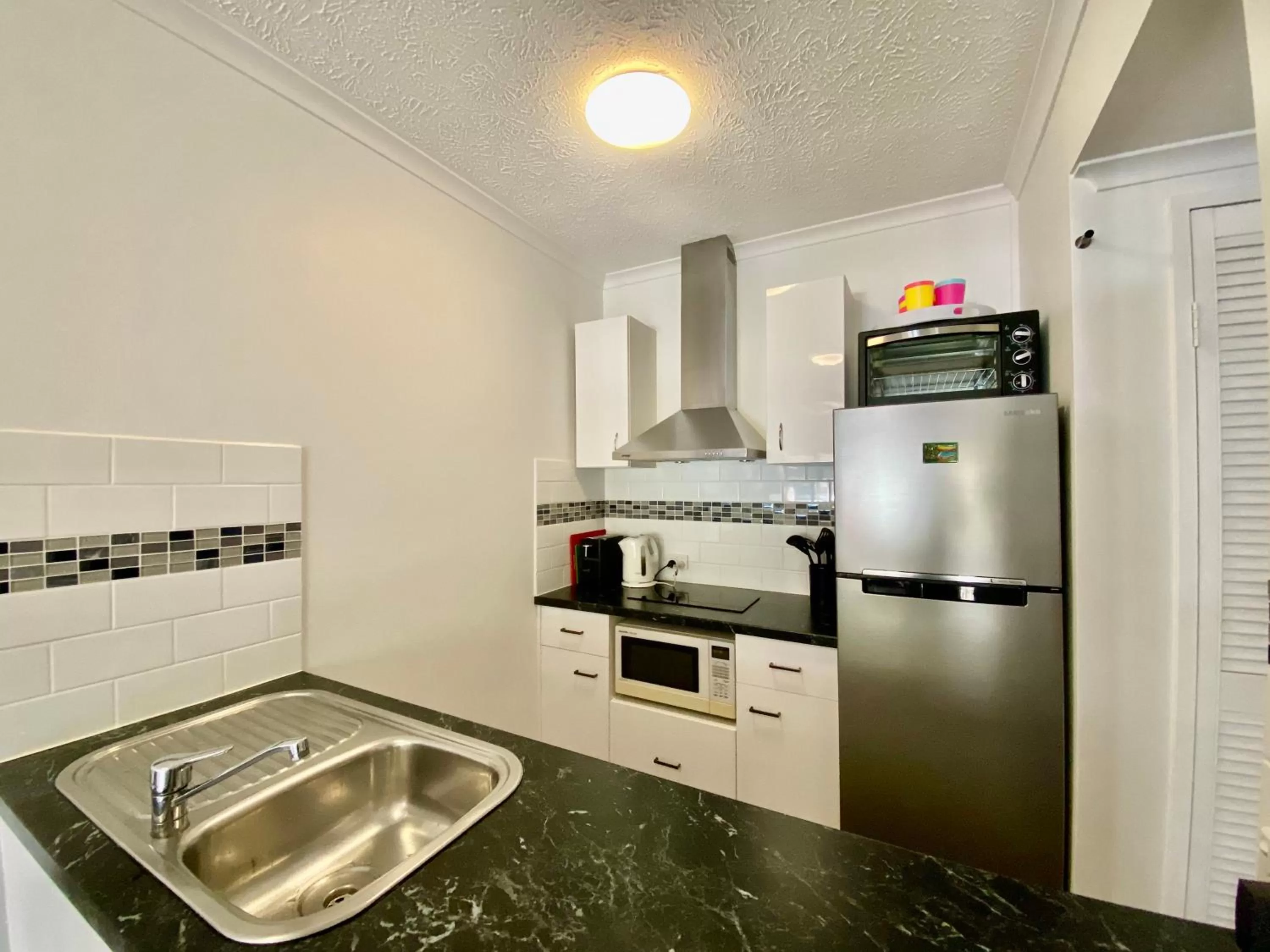 Kitchen or kitchenette in Cairns Beach Resort