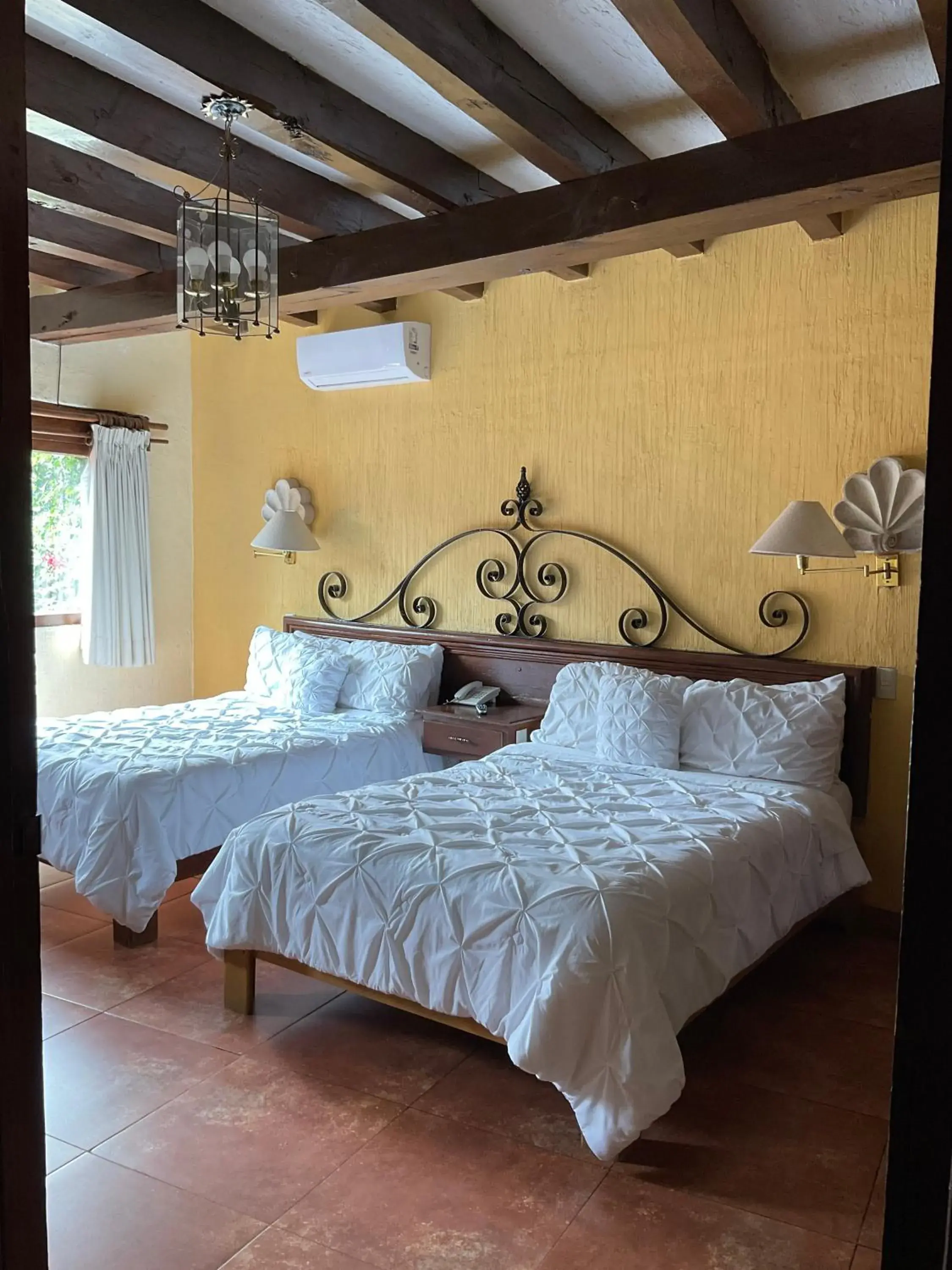 Bed in Villa San Jose Hotel & Suites