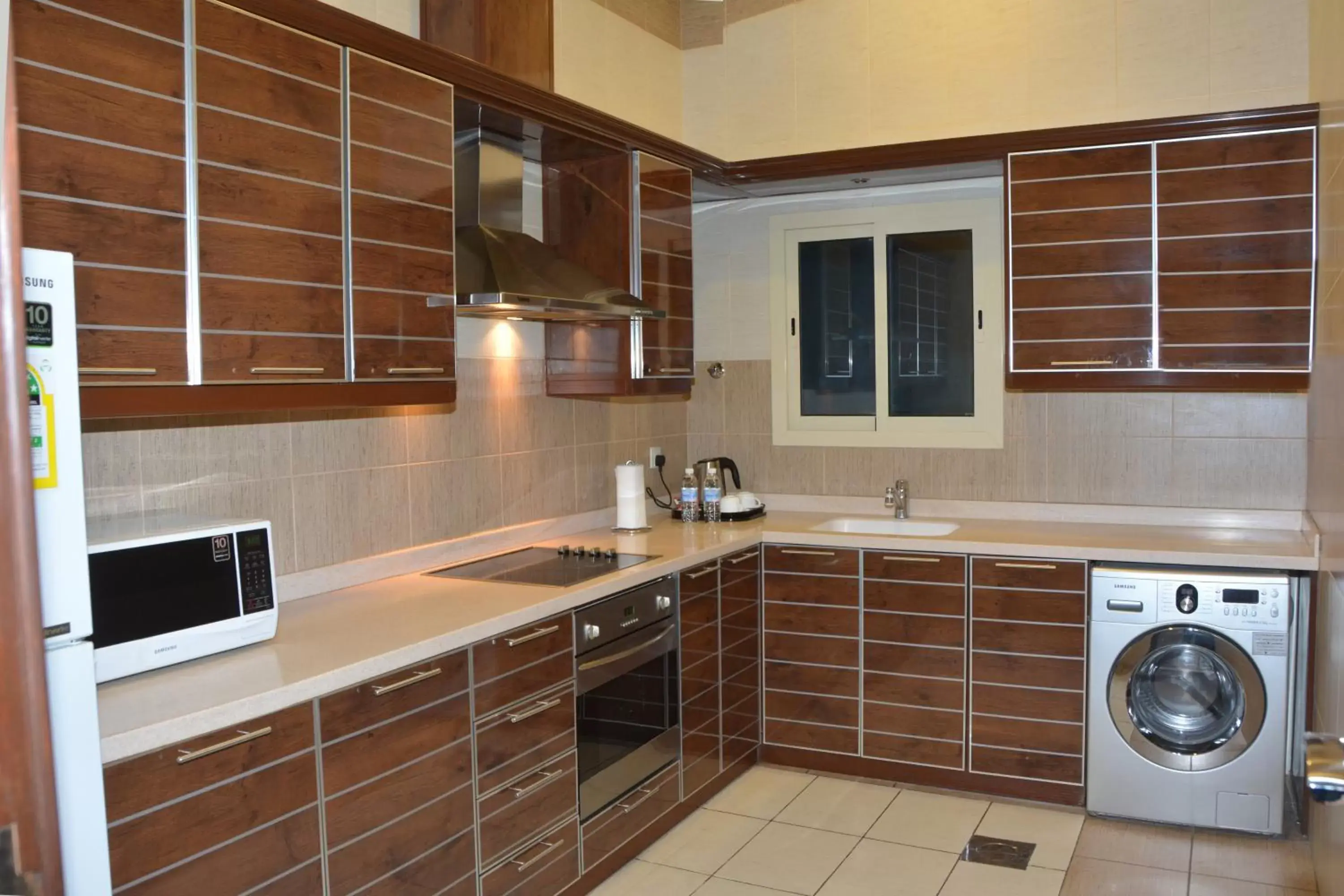 Kitchen or kitchenette in Mandarin Alshamal Hotel Apartments Kitchen or kitchenette in Mandarin Alshamal Hotel Apartments