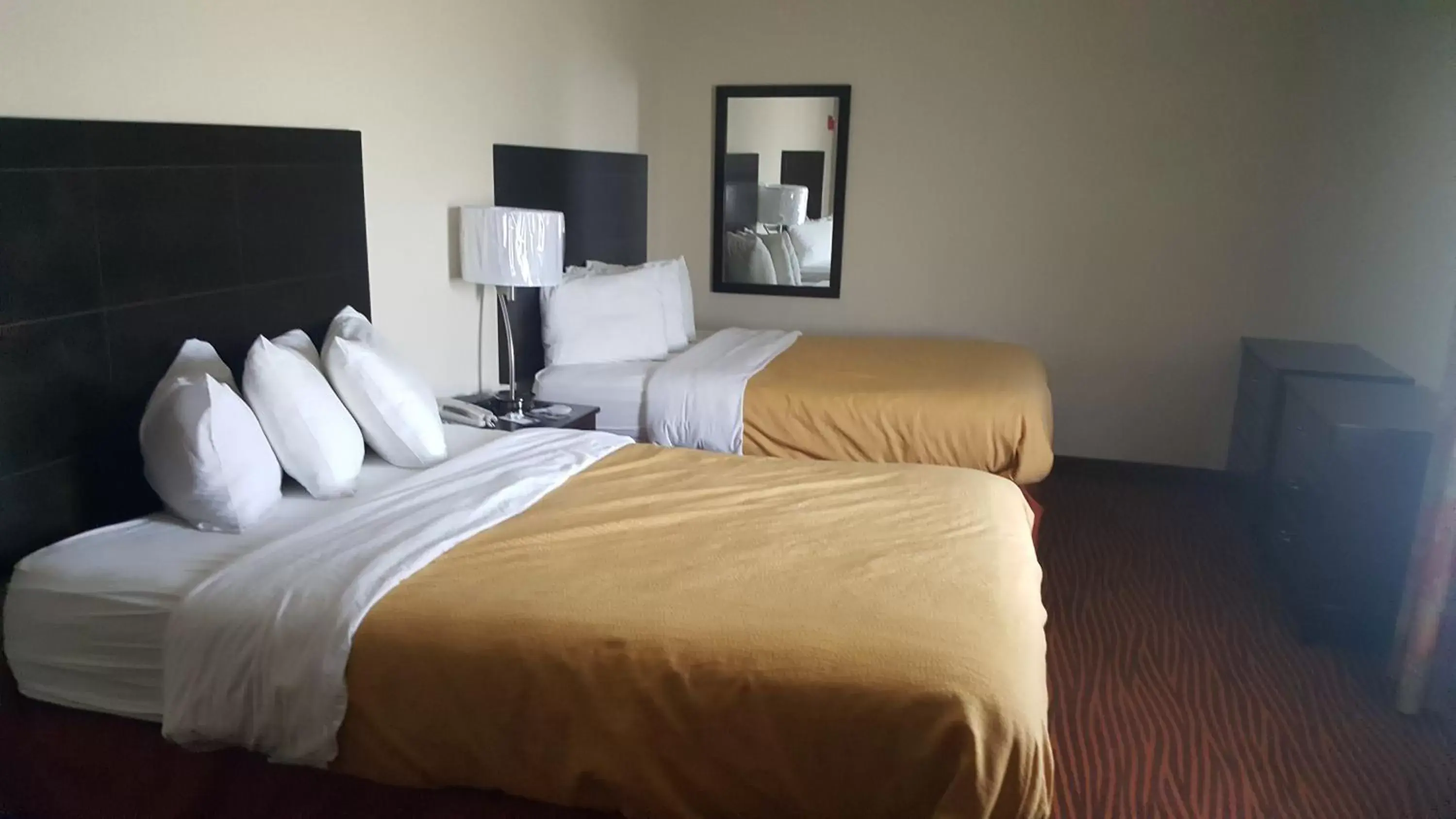 Bed in AmericInn by Wyndham Muscatine