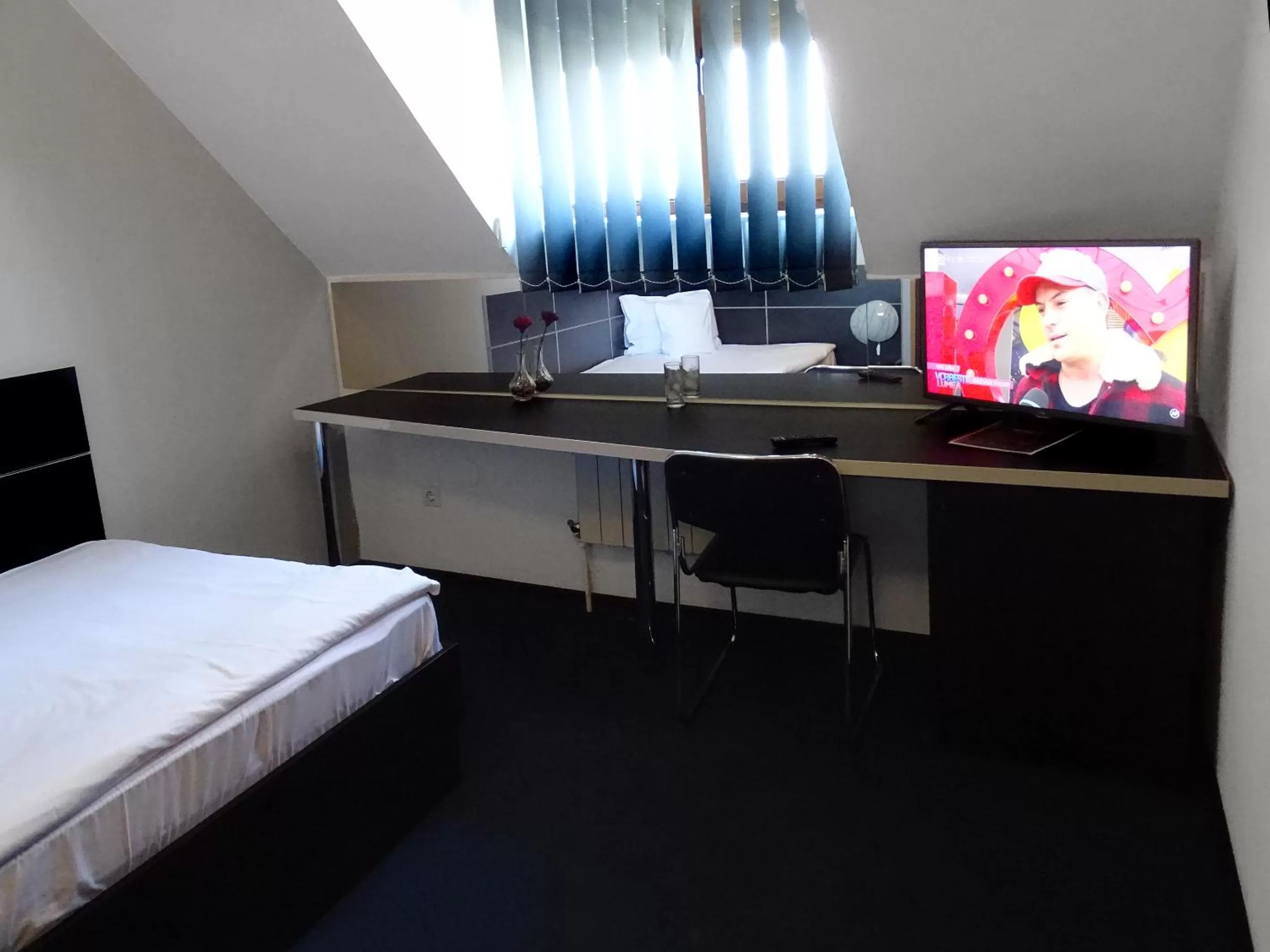 Bed, TV/Entertainment Center in Prince Hotel