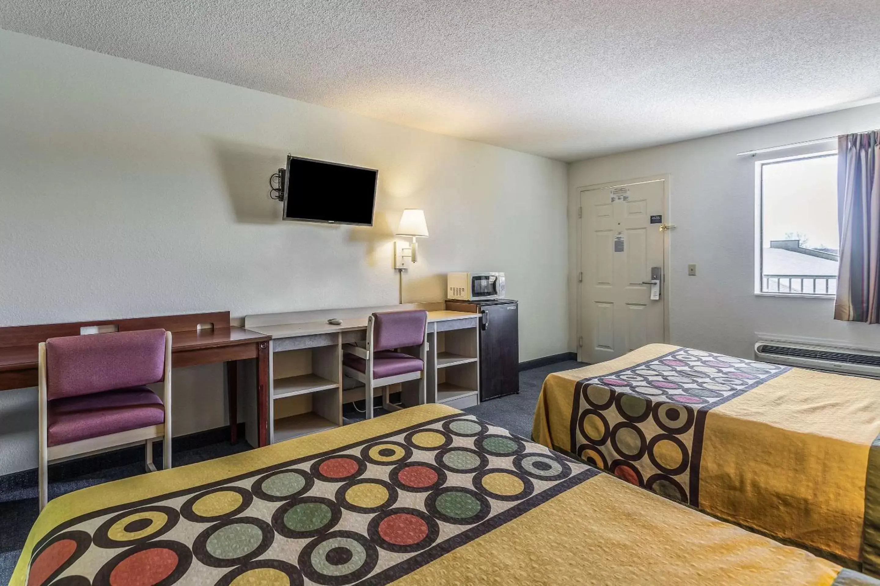 Photo of the whole room, TV/Entertainment Center in Rodeway Inn