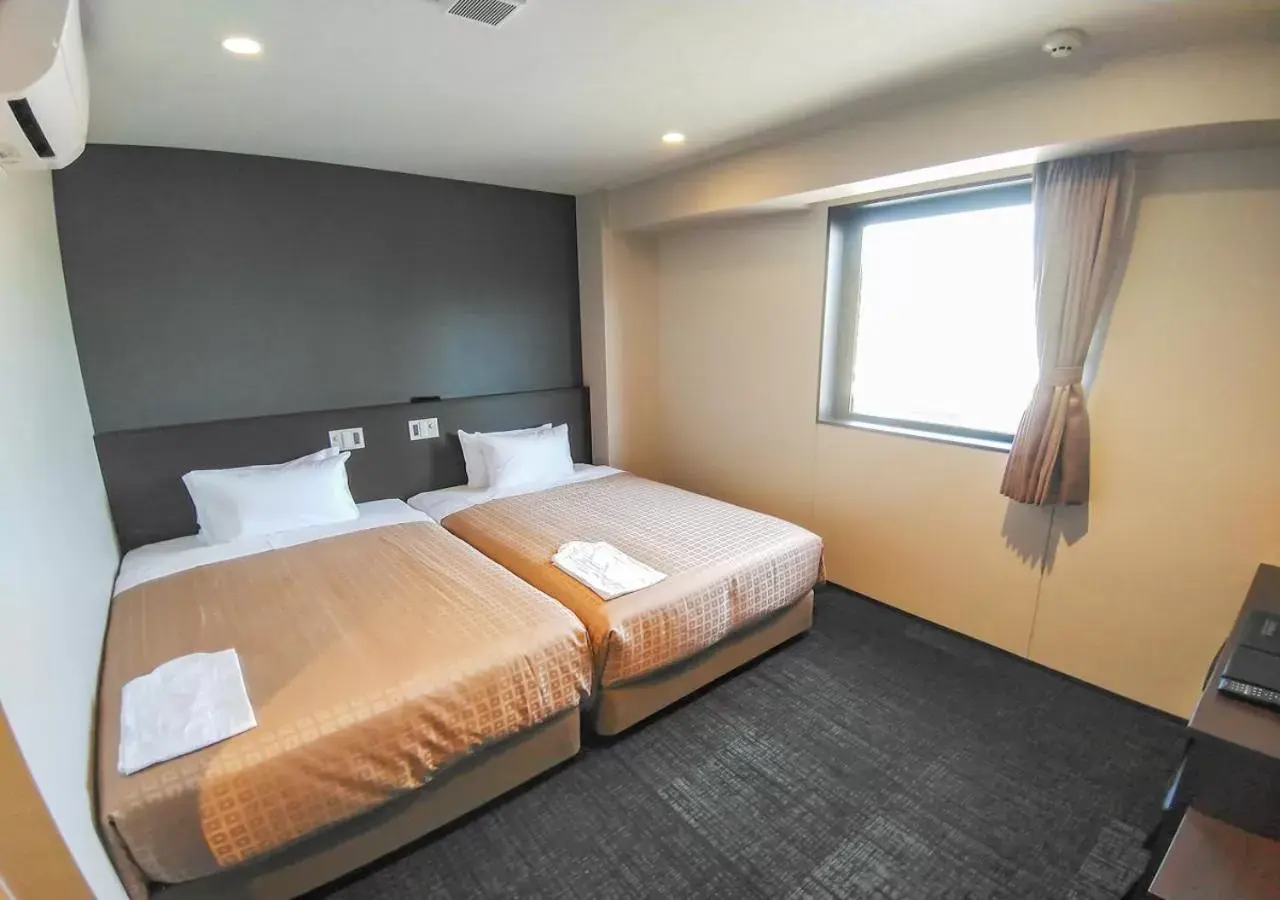 Bed in HOTEL LiVEMAX Kokura Ekimae