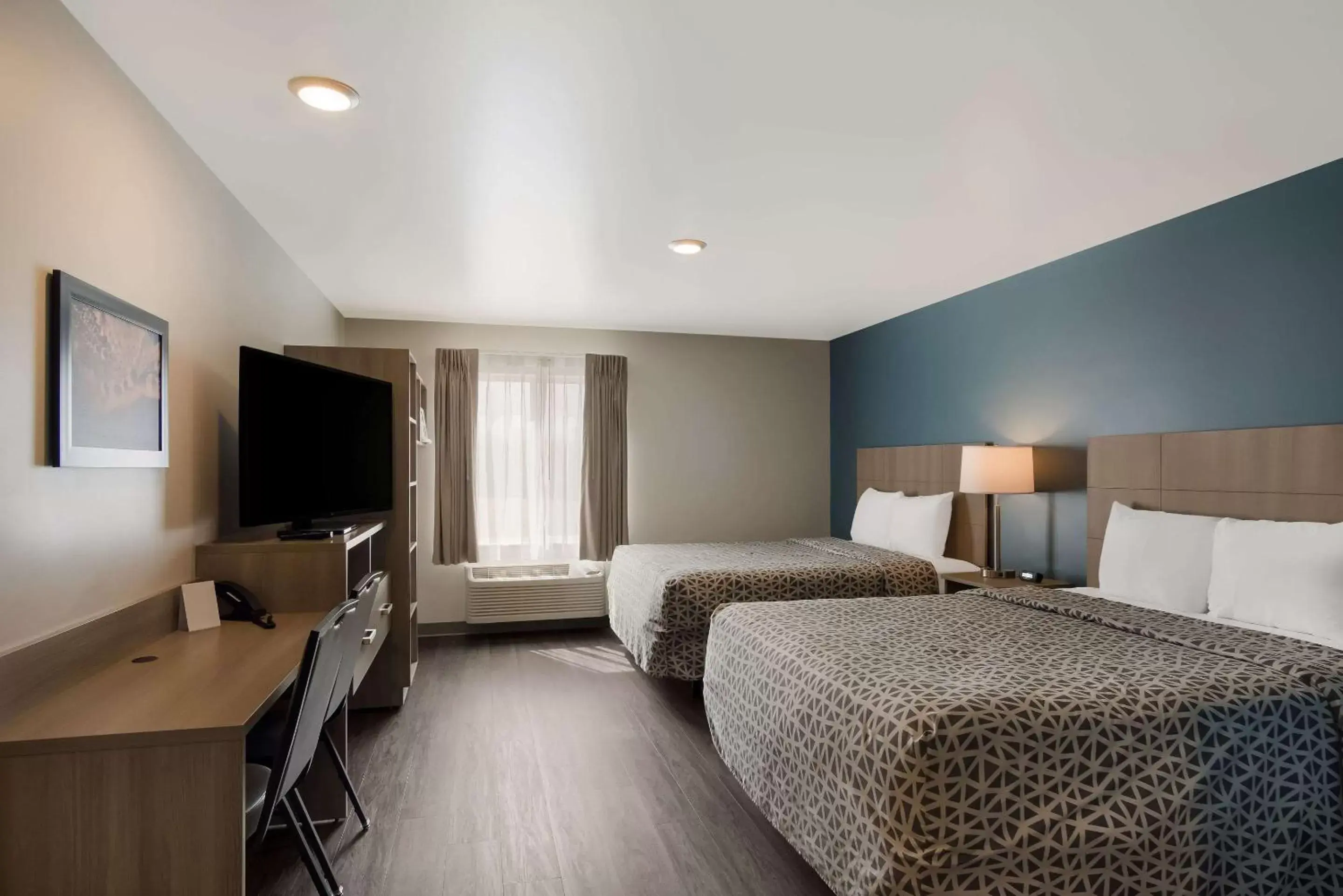 Bedroom in WoodSpring Suites Grand Rapids Kentwood
