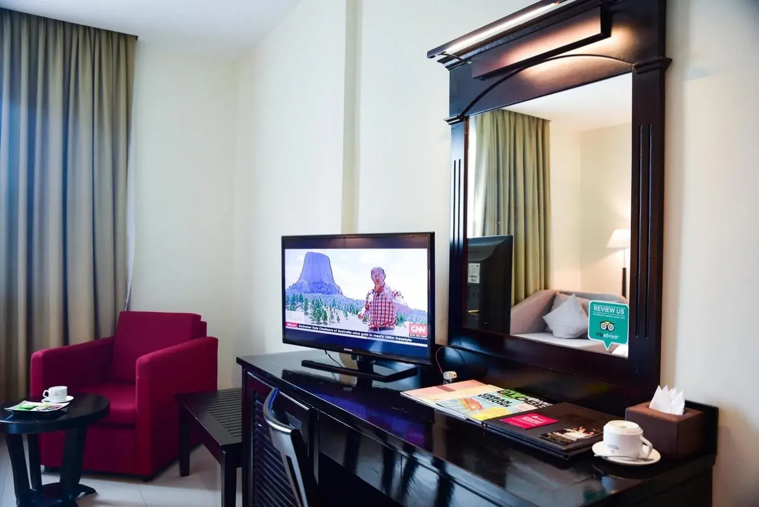 TV and multimedia, TV/Entertainment Center in Almond Hotel Sothearos