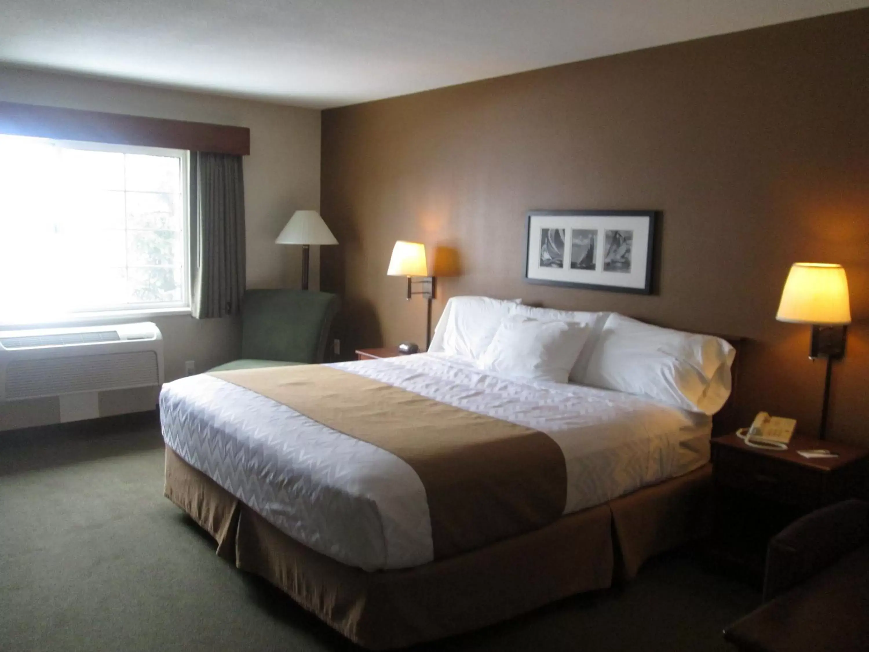 Bed in AmericInn by Wyndham Charlevoix