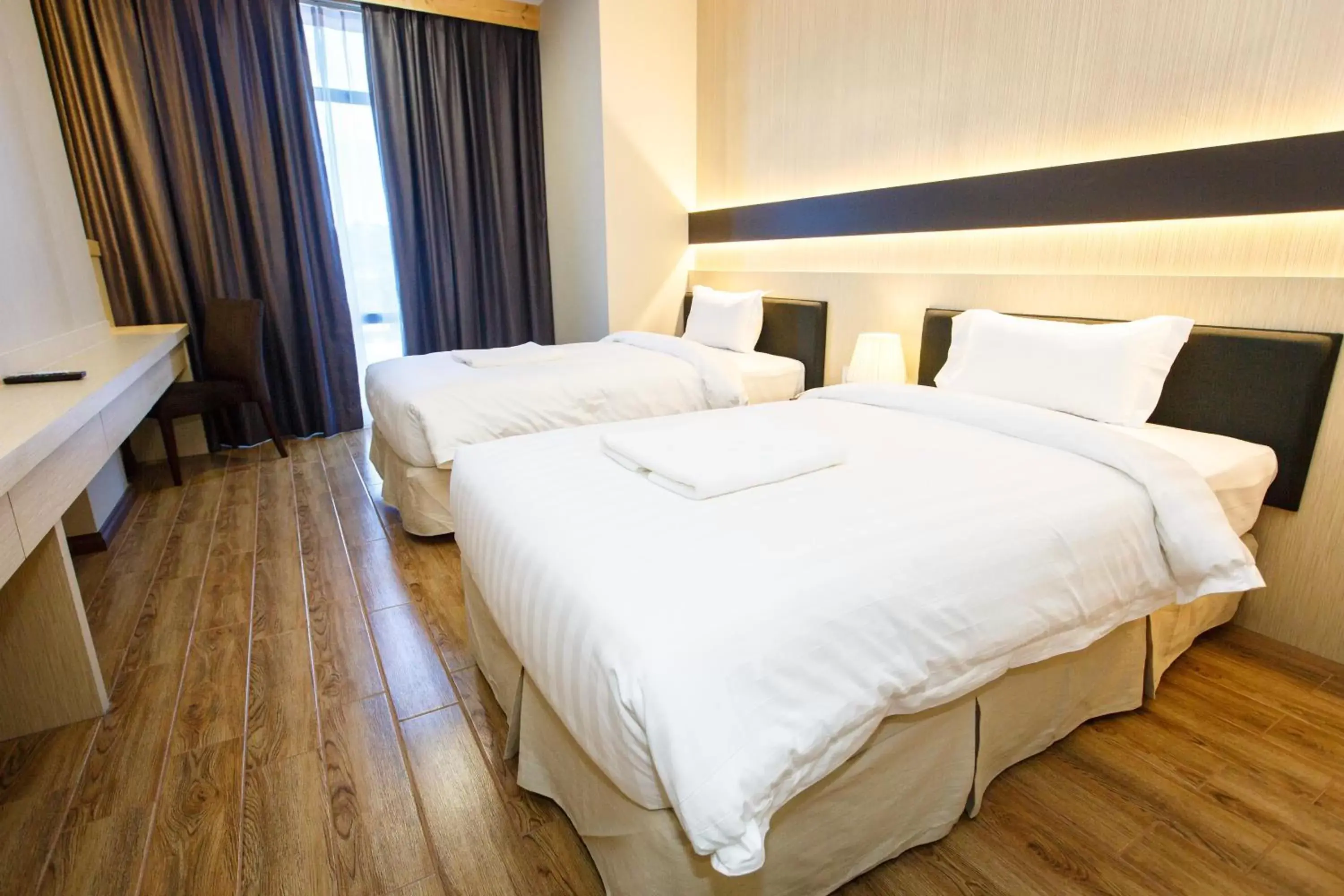 Bed in Lintas Platinum Hotel